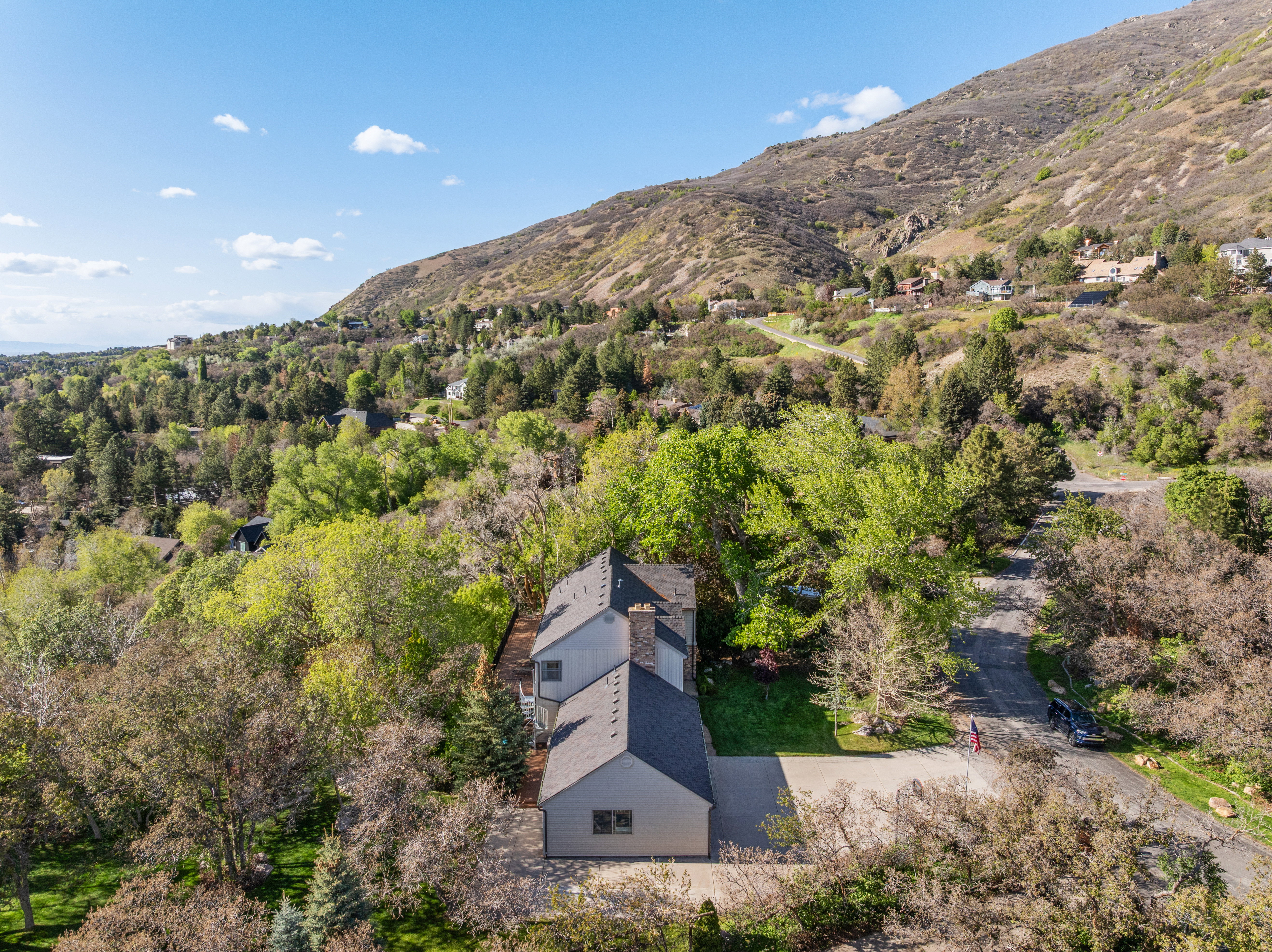 Contemporary residence featuring a dark gray exterior, multiple gables, and a prominent chimney