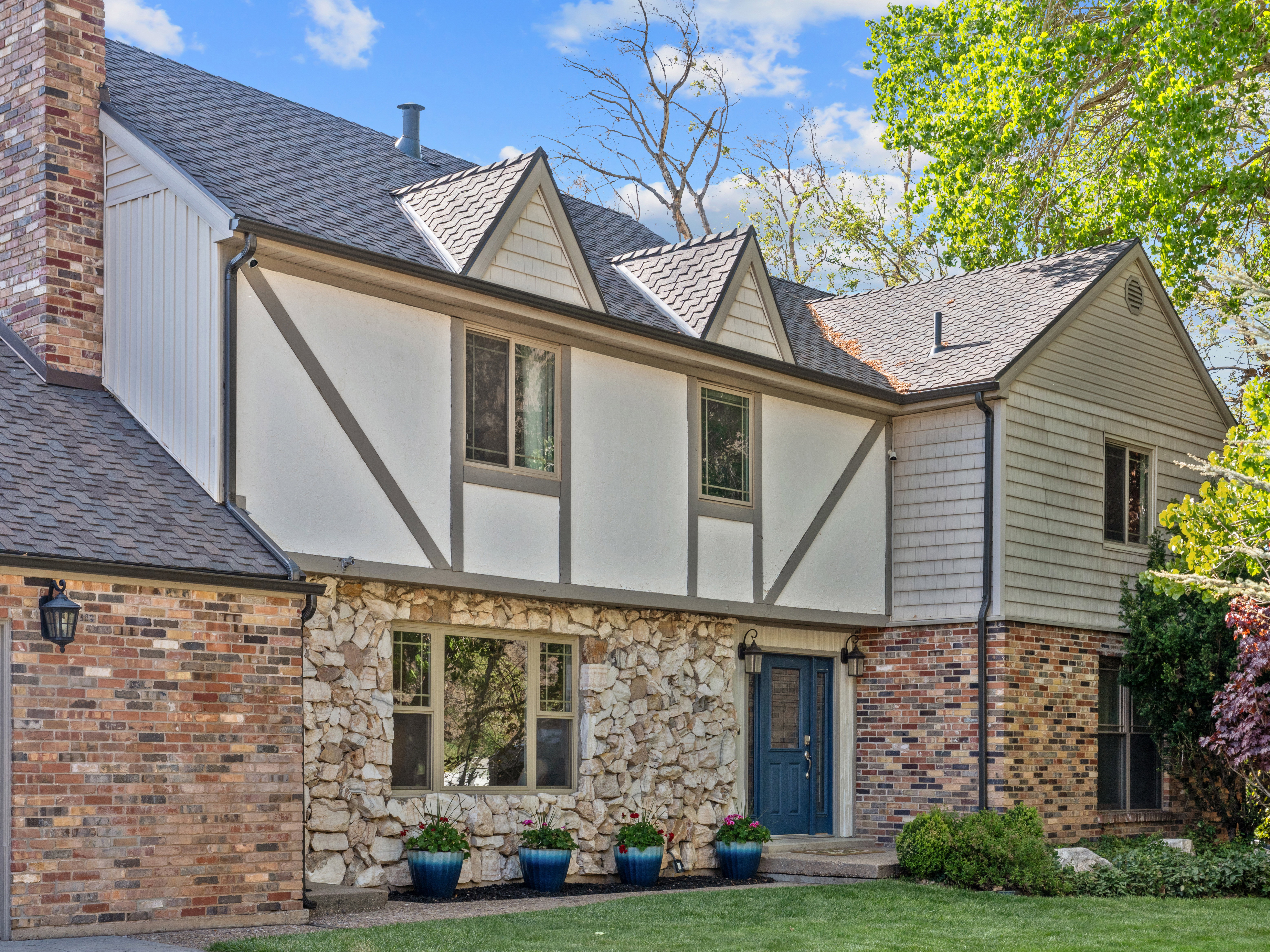 Multi-textured exterior featuring brick, stone, and siding accents