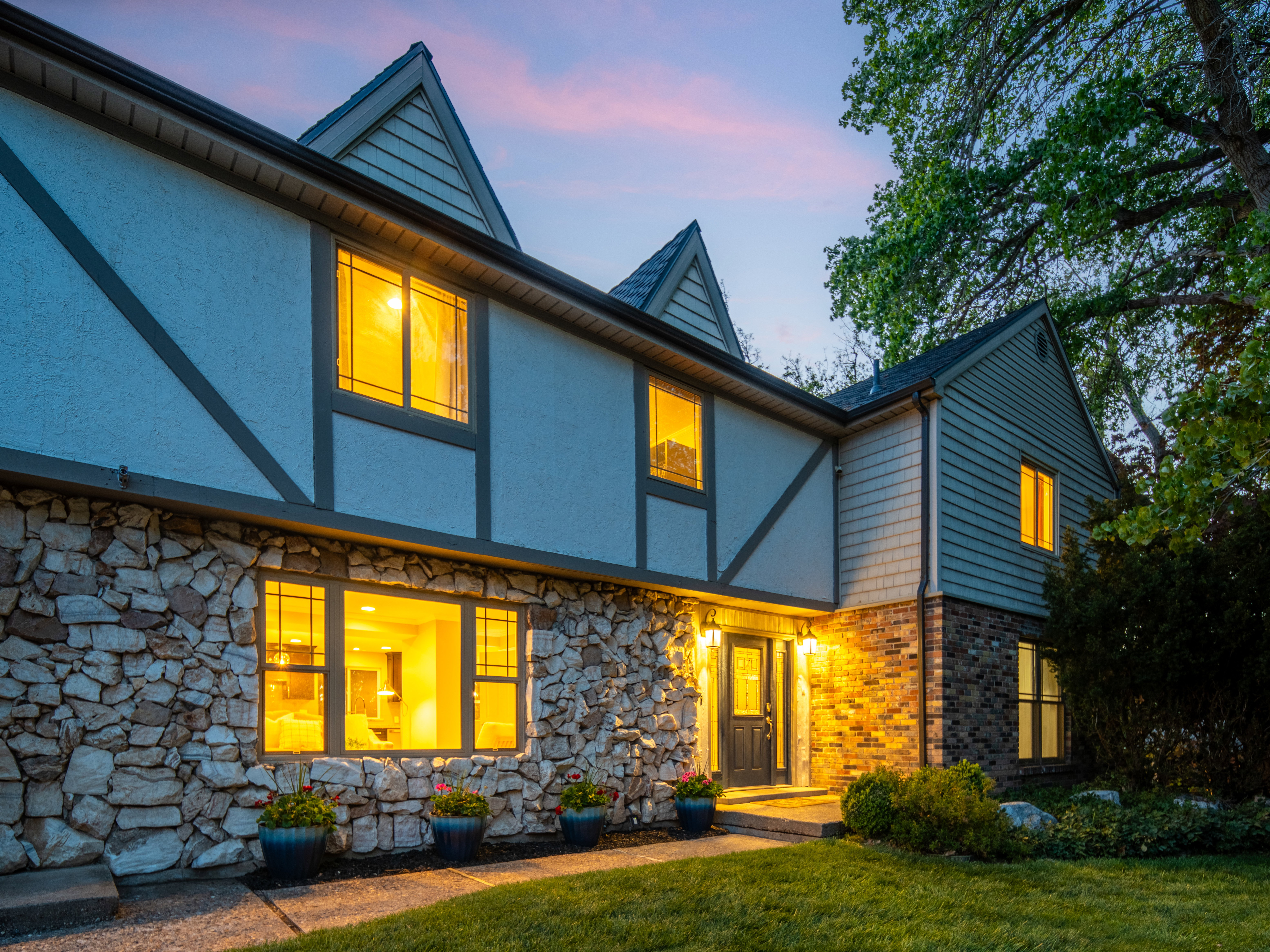 Multi-level exterior featuring a stone and siding facade