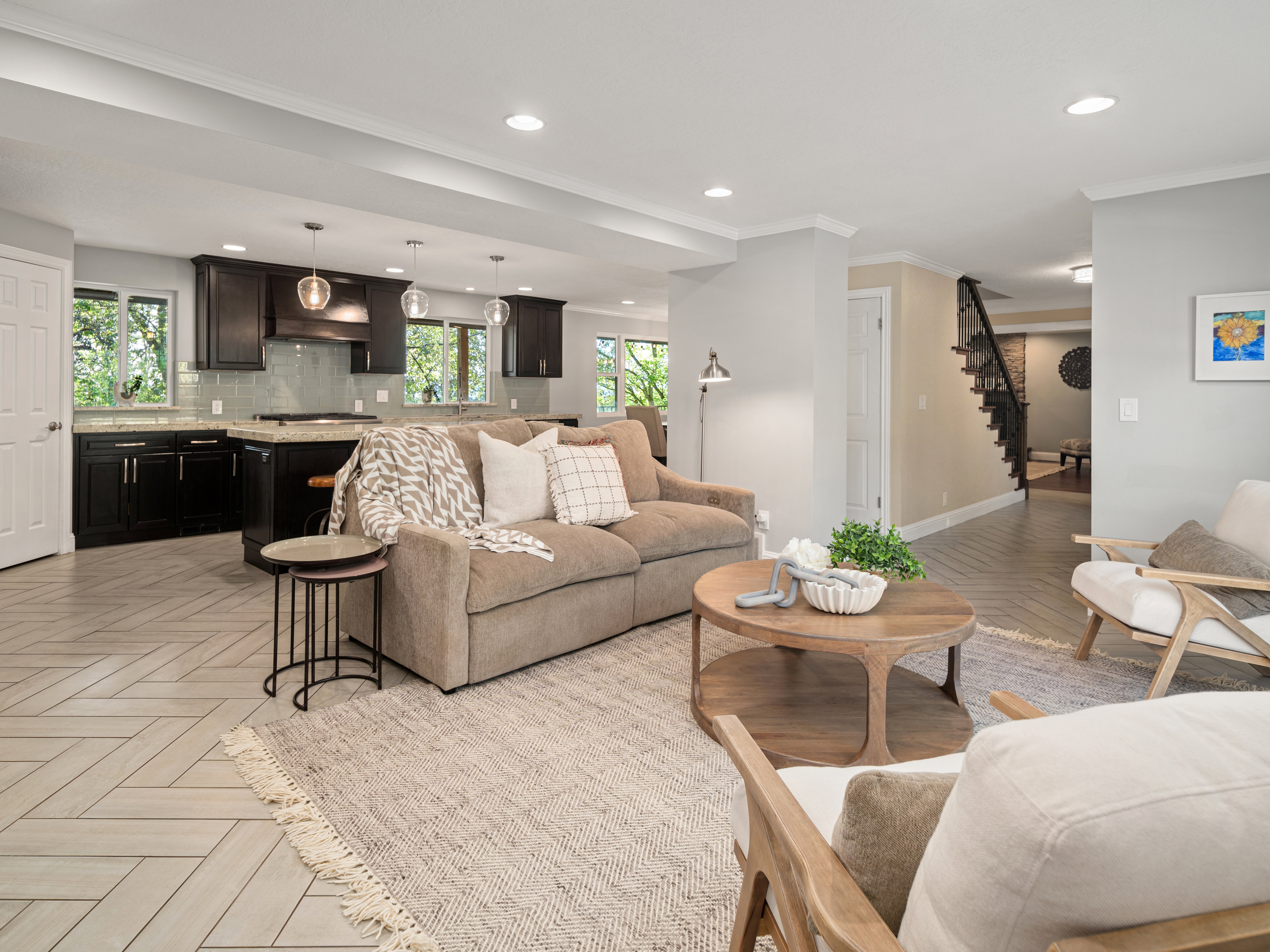 Open-concept living space with herringbone-patterned tile flooring