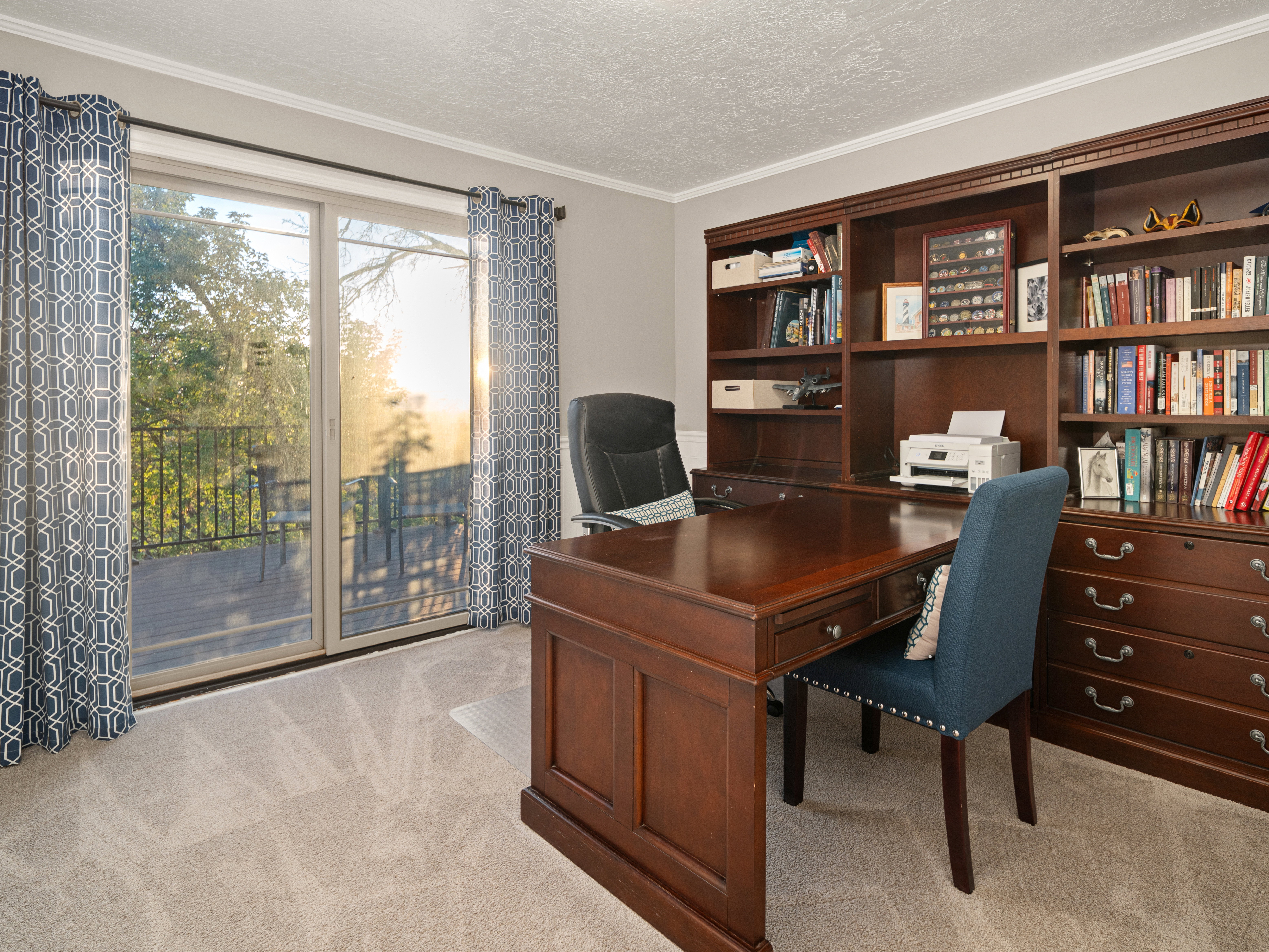 Office space featuring a built-in dark wood desk and shelving unit