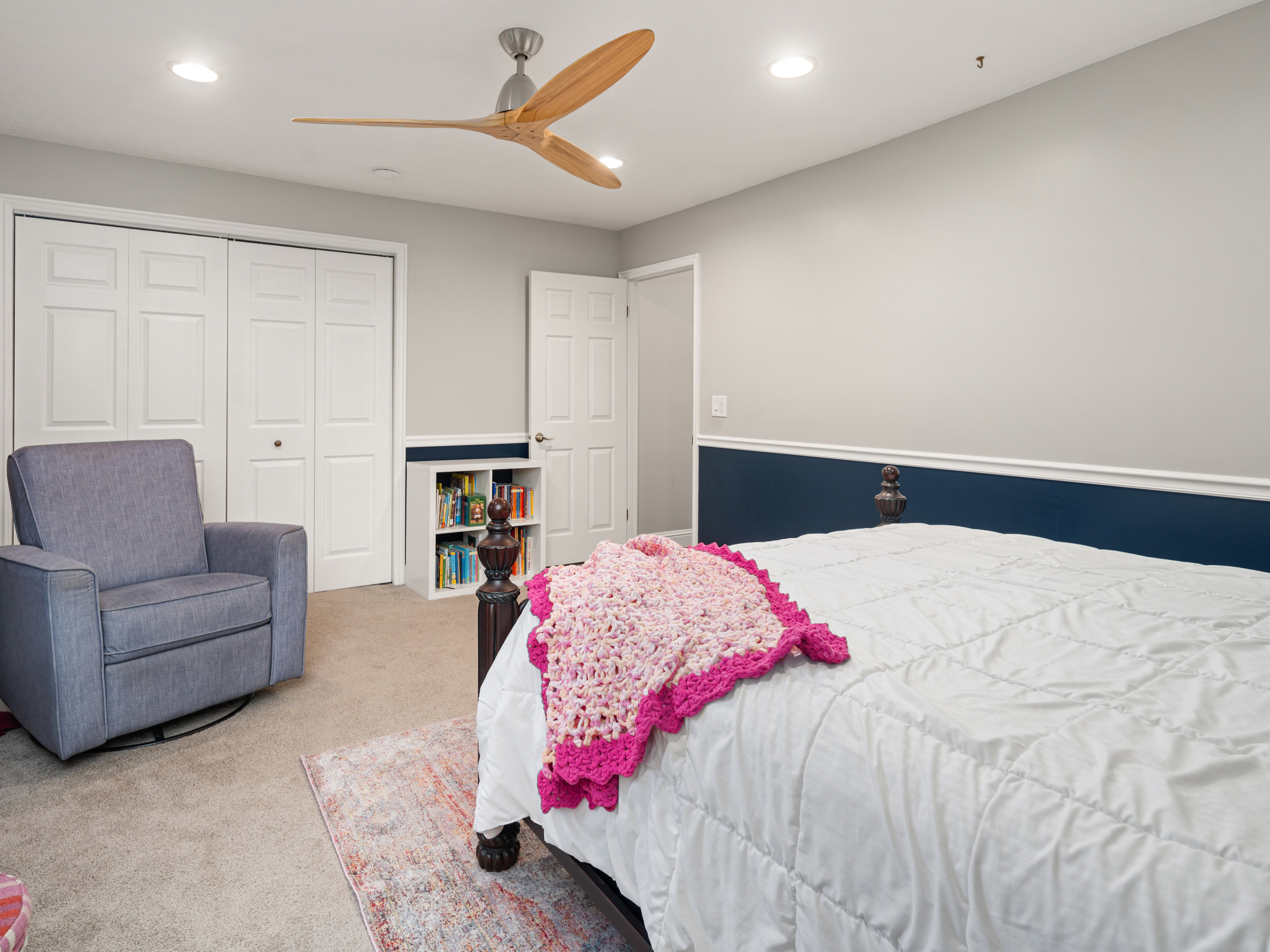 Bedroom featuring neutral wall paint with a contrasting chair rail, recessed lighting, and a contemporary ceiling fan