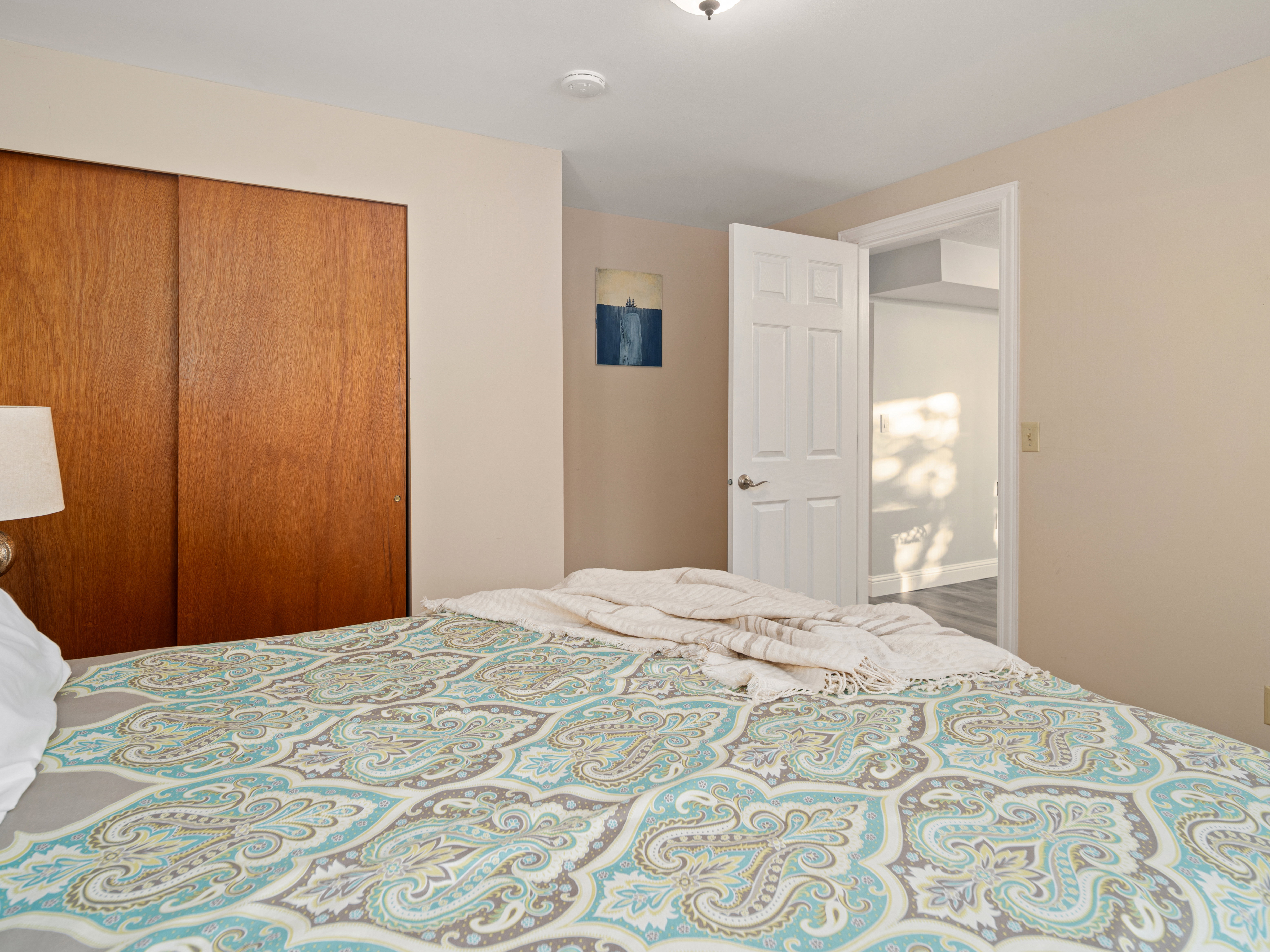 Warm-toned walls complement a substantial built-in closet with sliding wood-finish doors