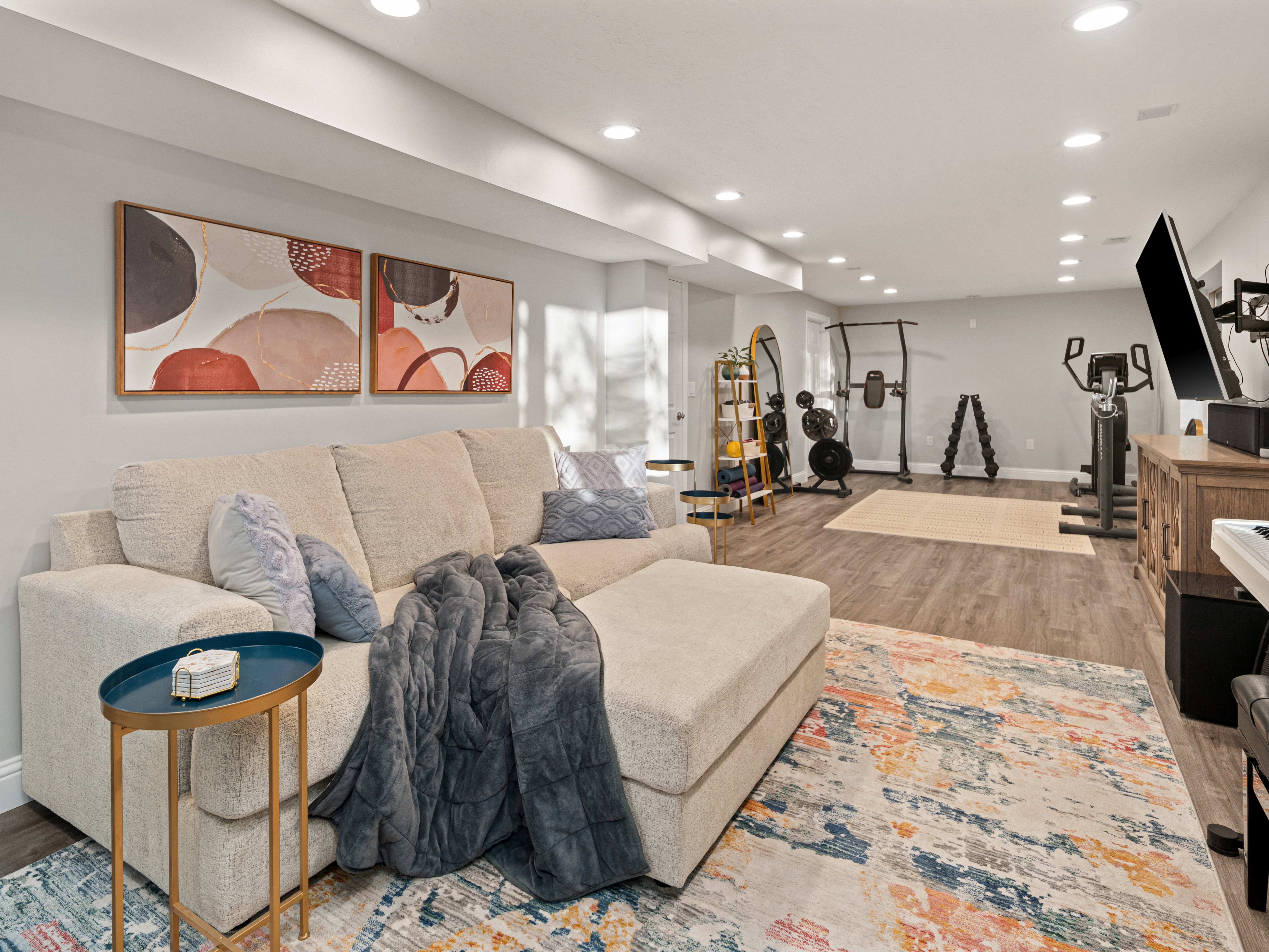Spacious room featuring recessed lighting, light gray walls, and wood-finish flooring