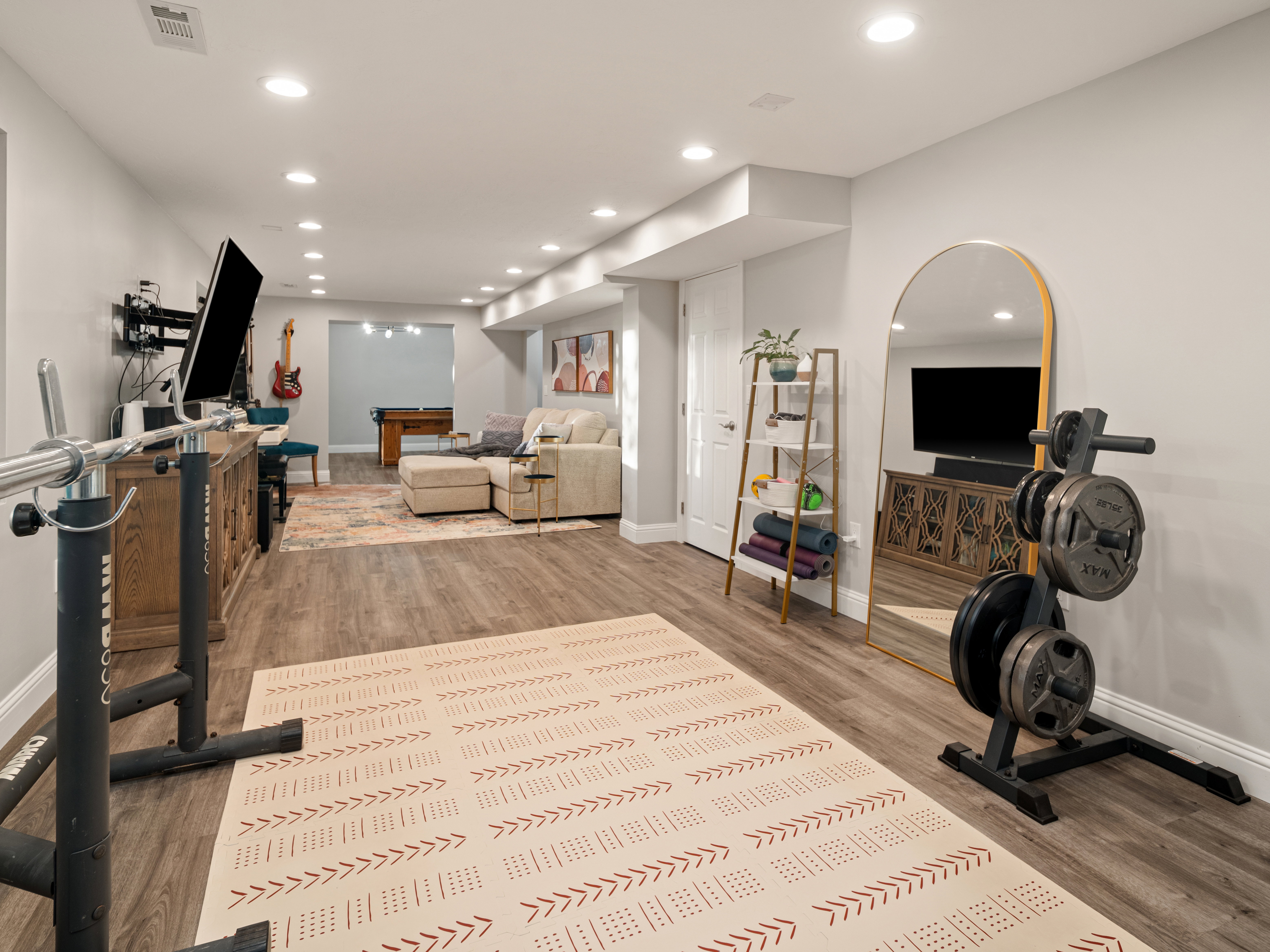 Spacious lower level featuring recessed lighting, durable wood-finish flooring, and white baseboards