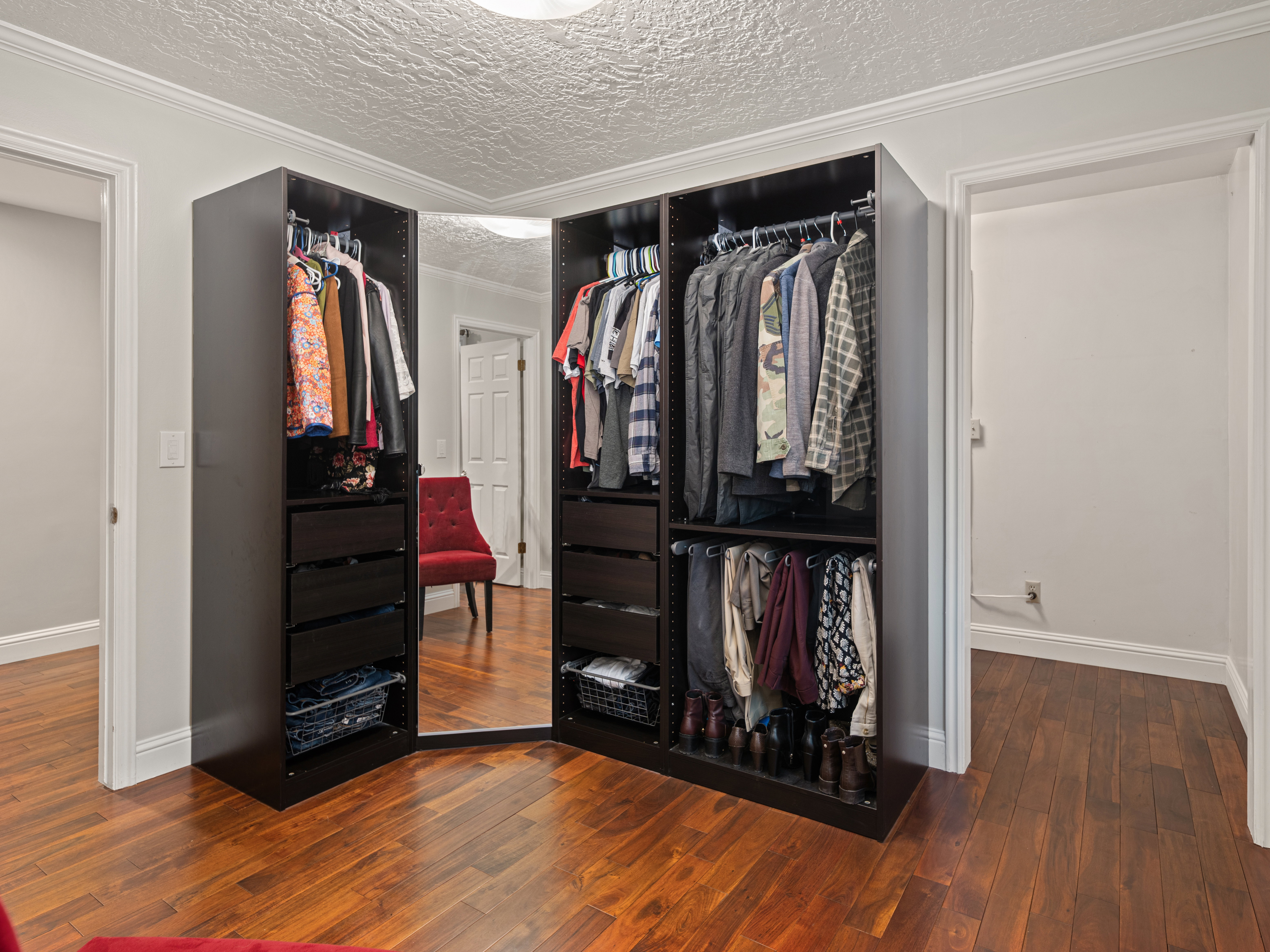 Custom built-in closet system featuring multiple hanging rods and integrated drawers