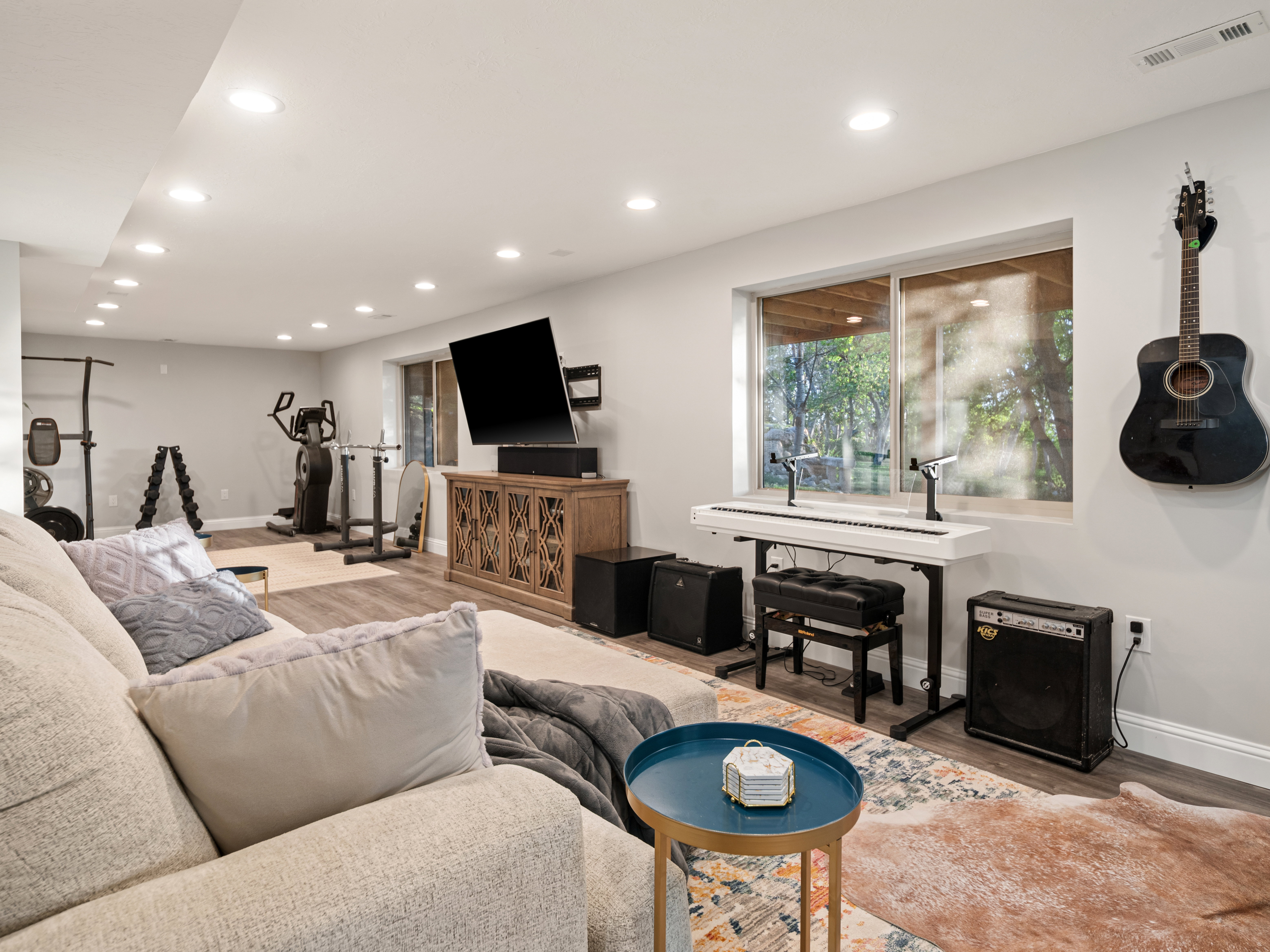 Spacious lower-level area featuring recessed lighting, wood-finish flooring, and a large sliding window