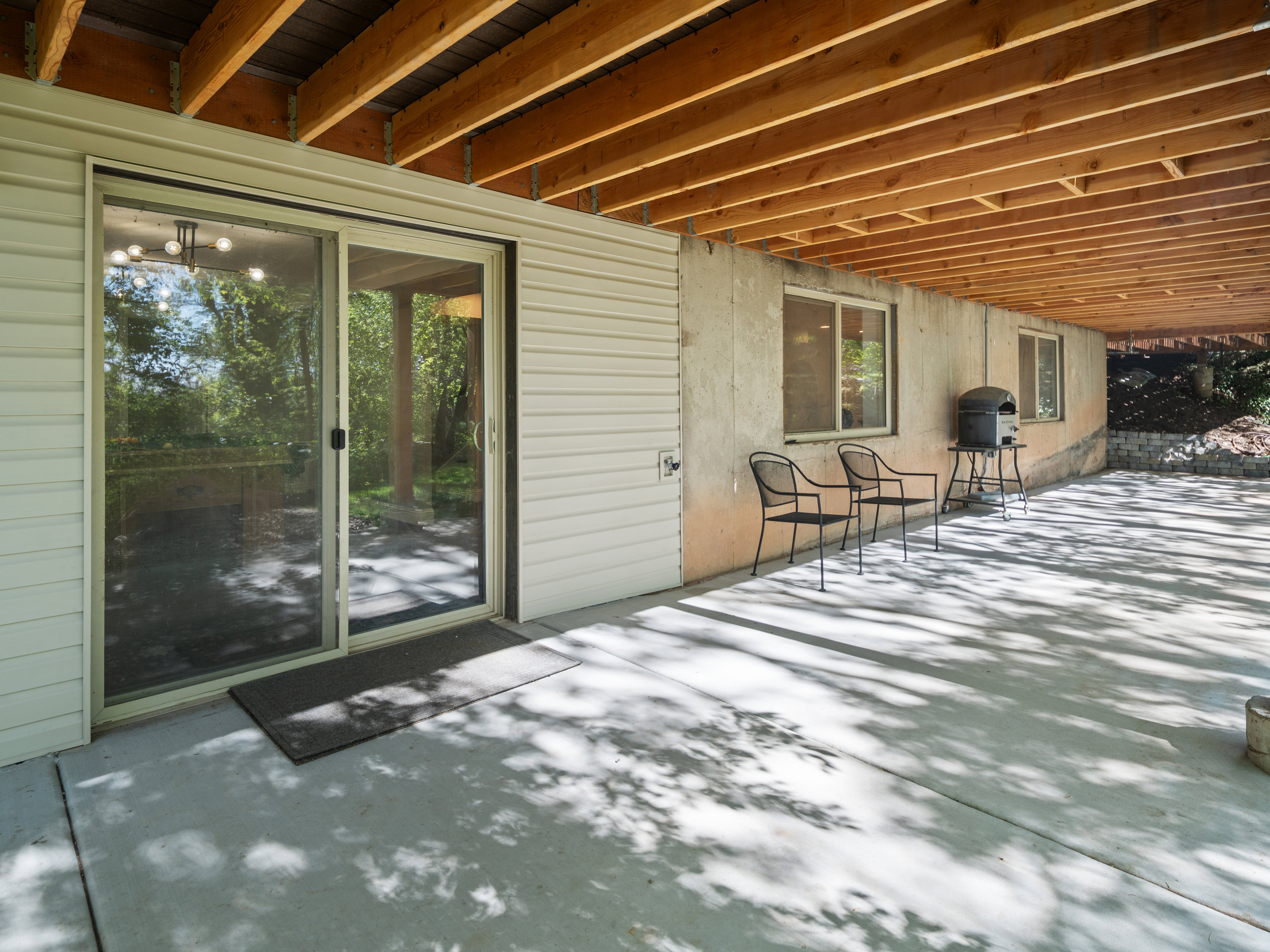 Concrete patio with exposed wood joist ceiling