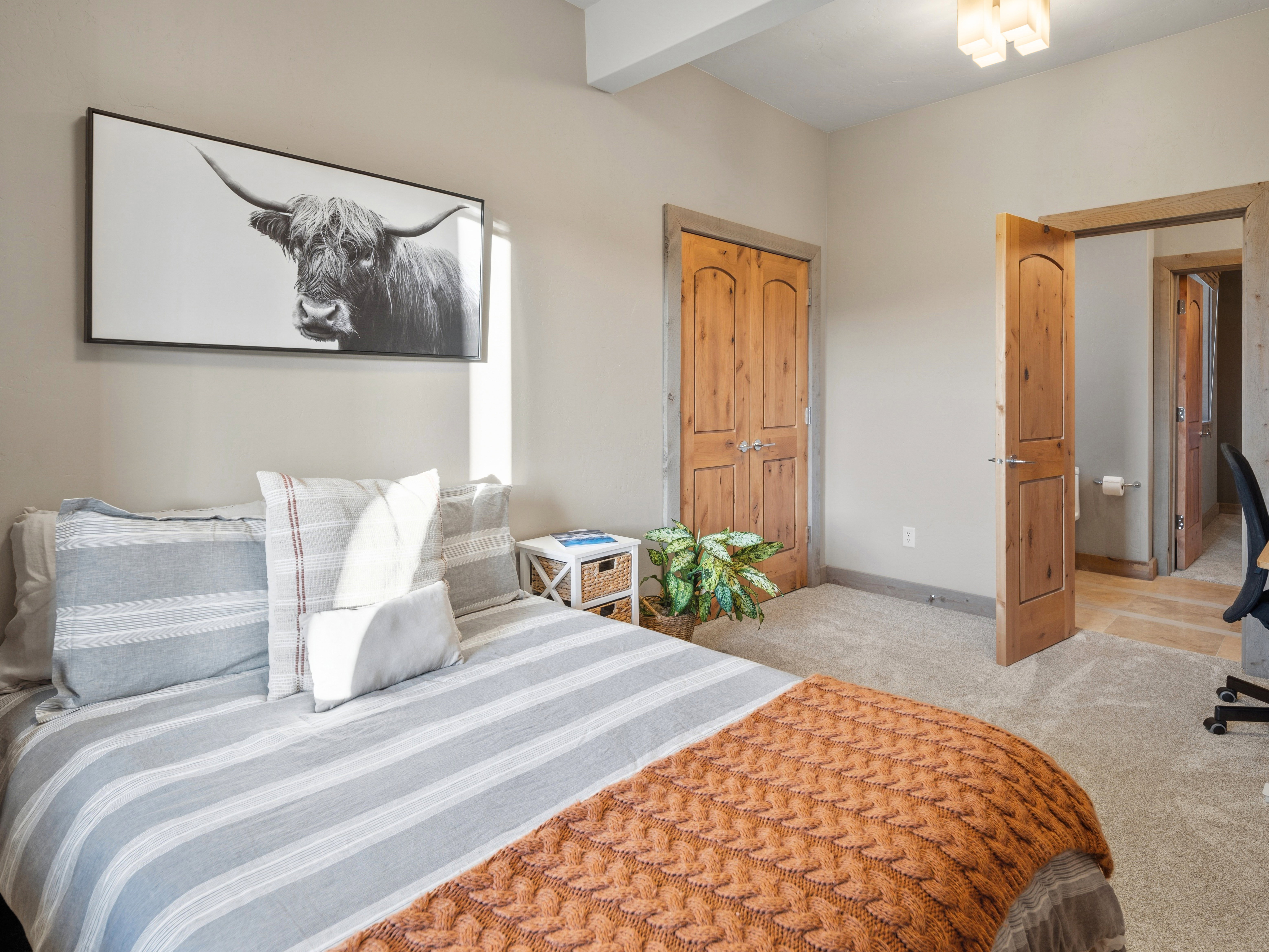 Neutral tone walls complement the wood-finish doors and trim