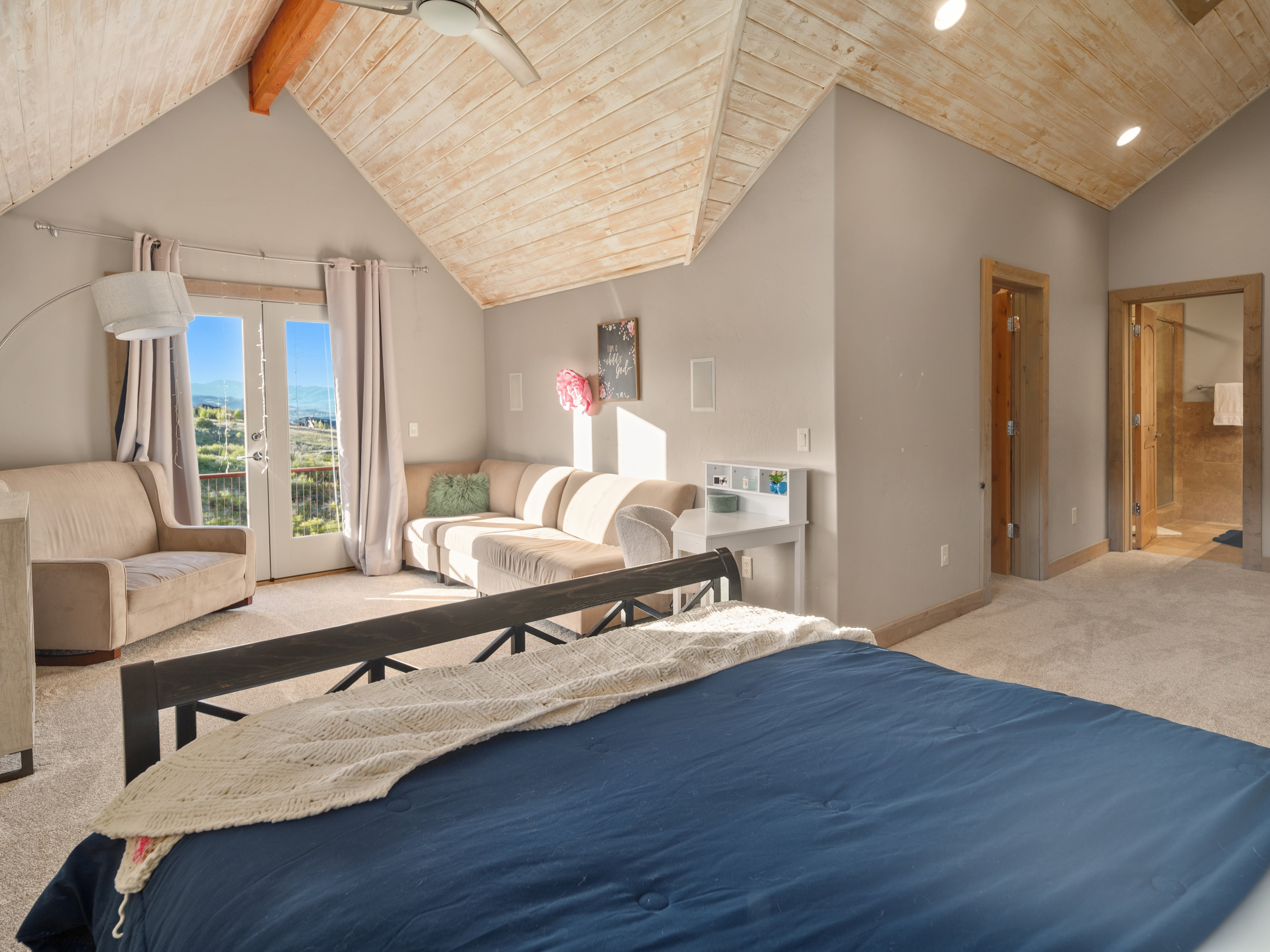 Vaulted wood-finish ceilings featuring exposed wood beams and recessed lighting