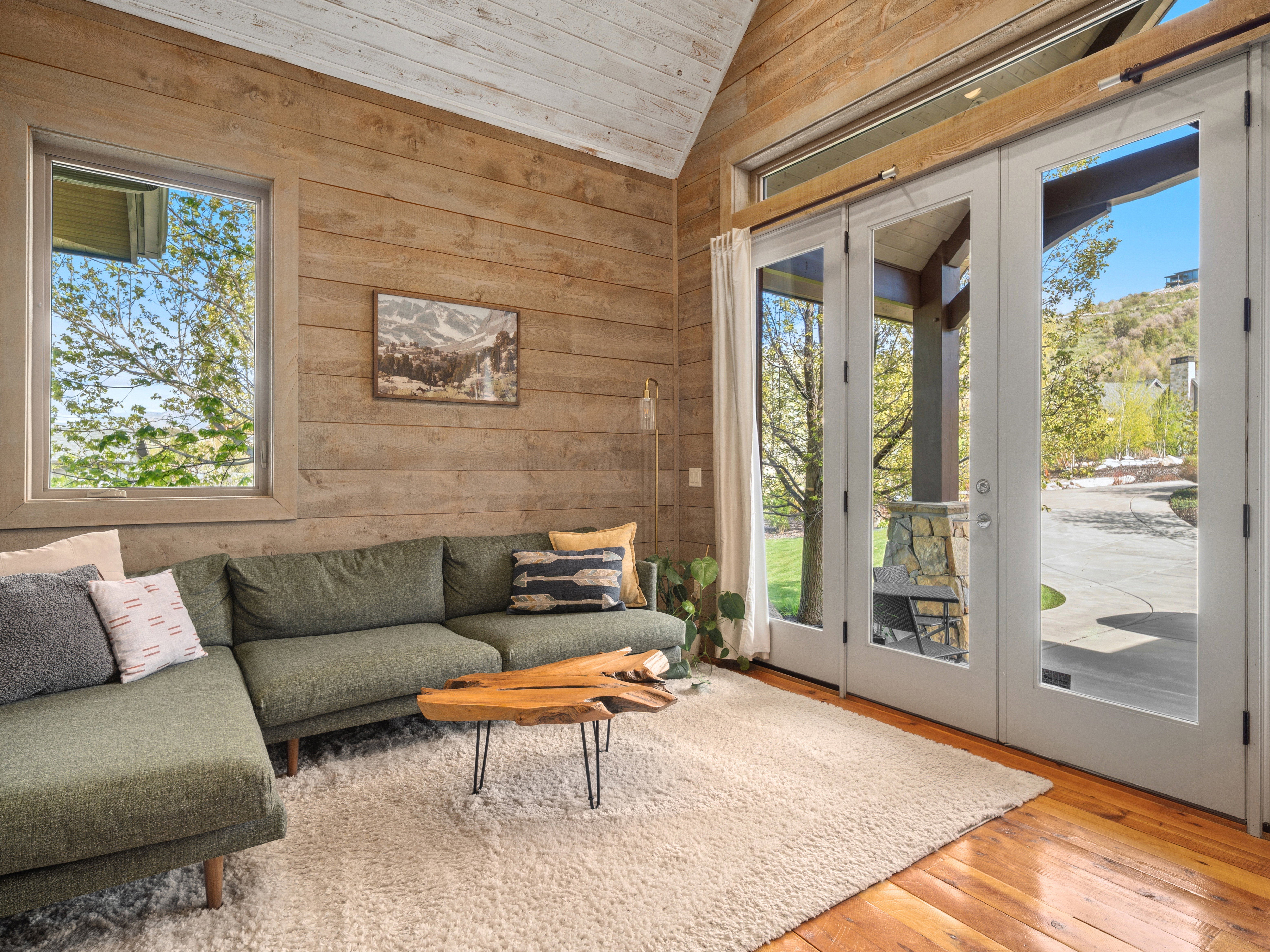 Interior room featuring natural wood plank walls, a vaulted wood plank ceiling, and wood-finish flooring