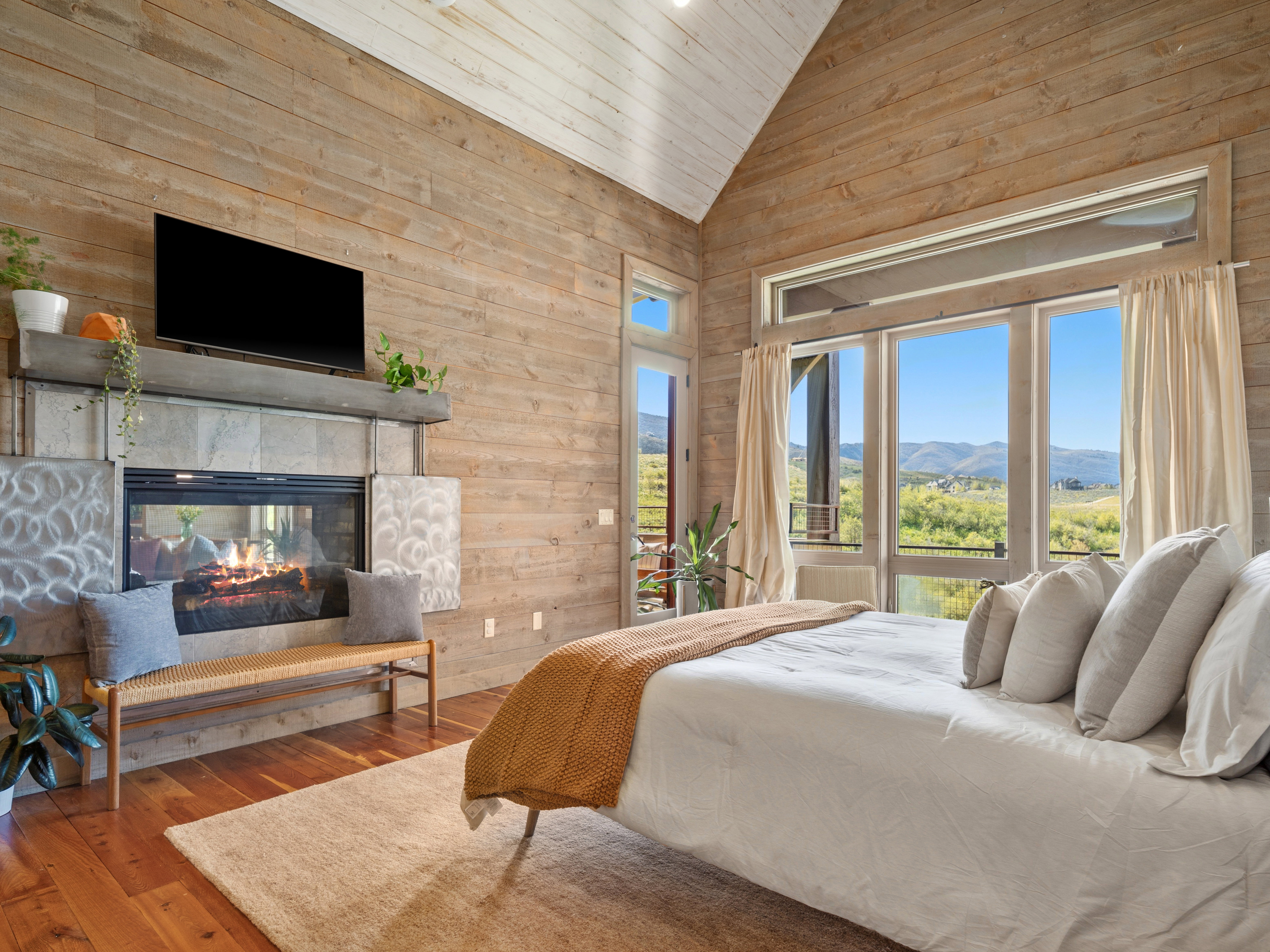 Vaulted wood-paneled ceiling with light wood-finish flooring