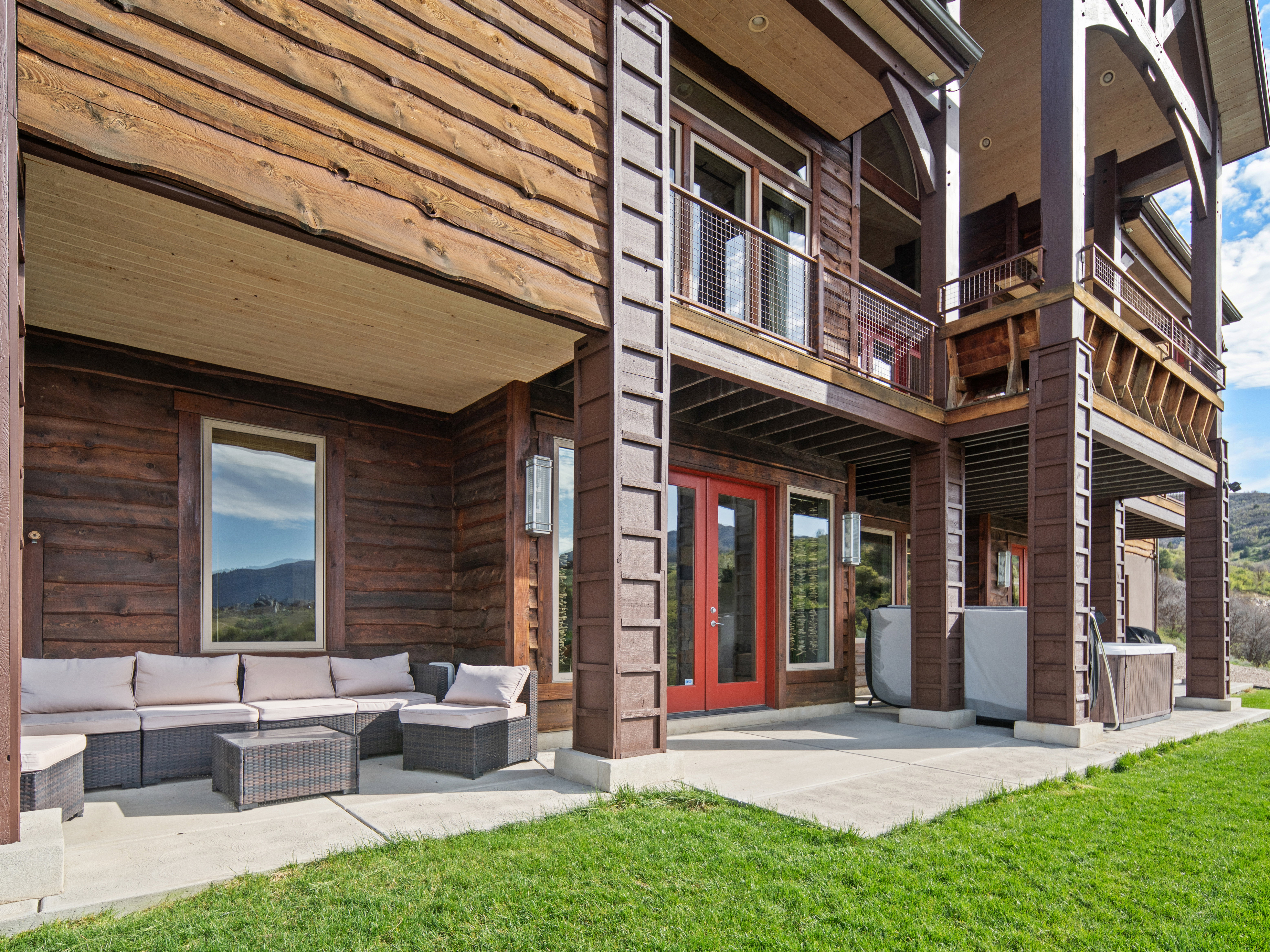Multi-level exterior featuring natural wood siding and prominent structural pillars