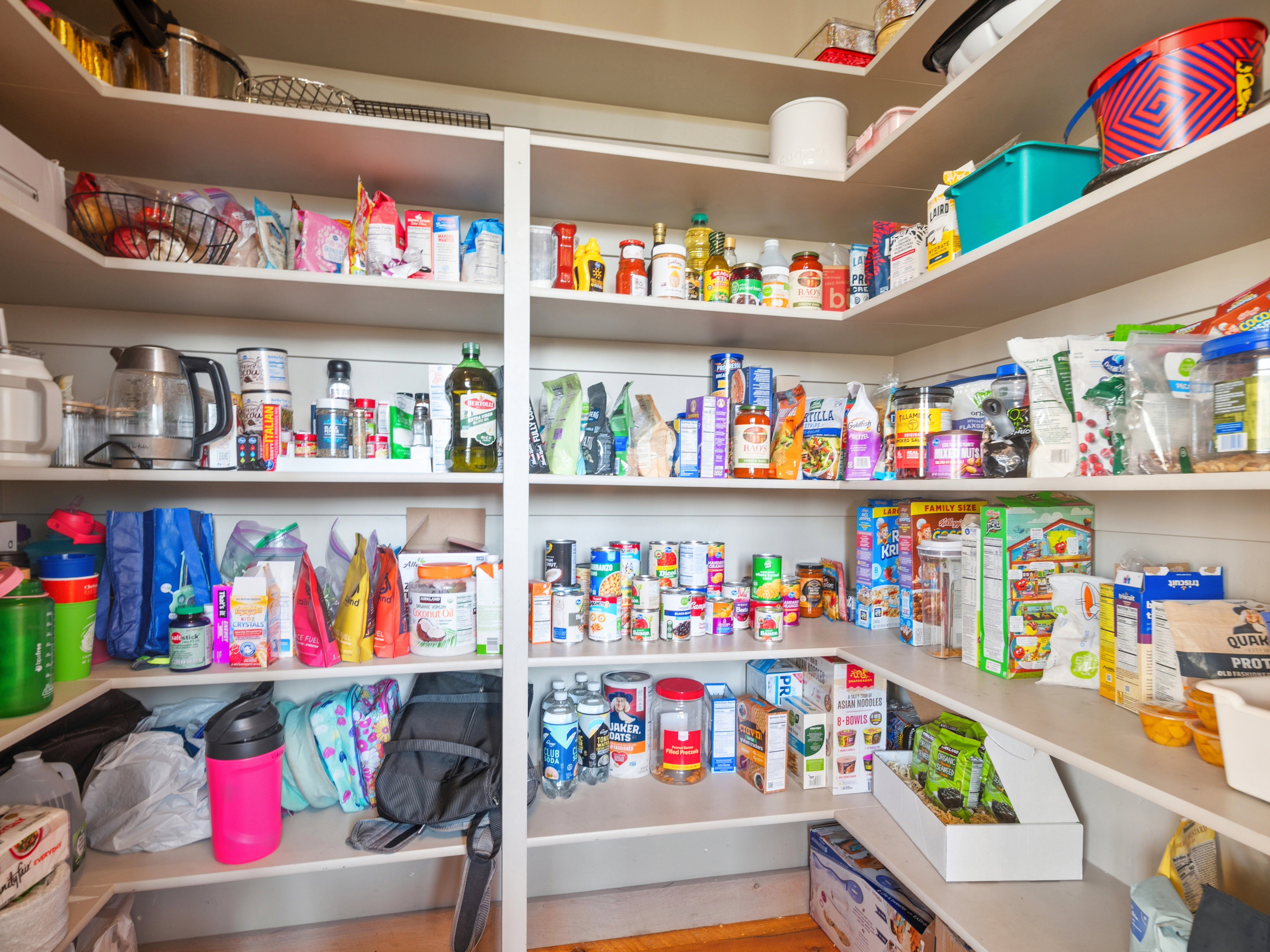 Spacious corner pantry featuring multiple levels of shelving, providing ample storage capacity