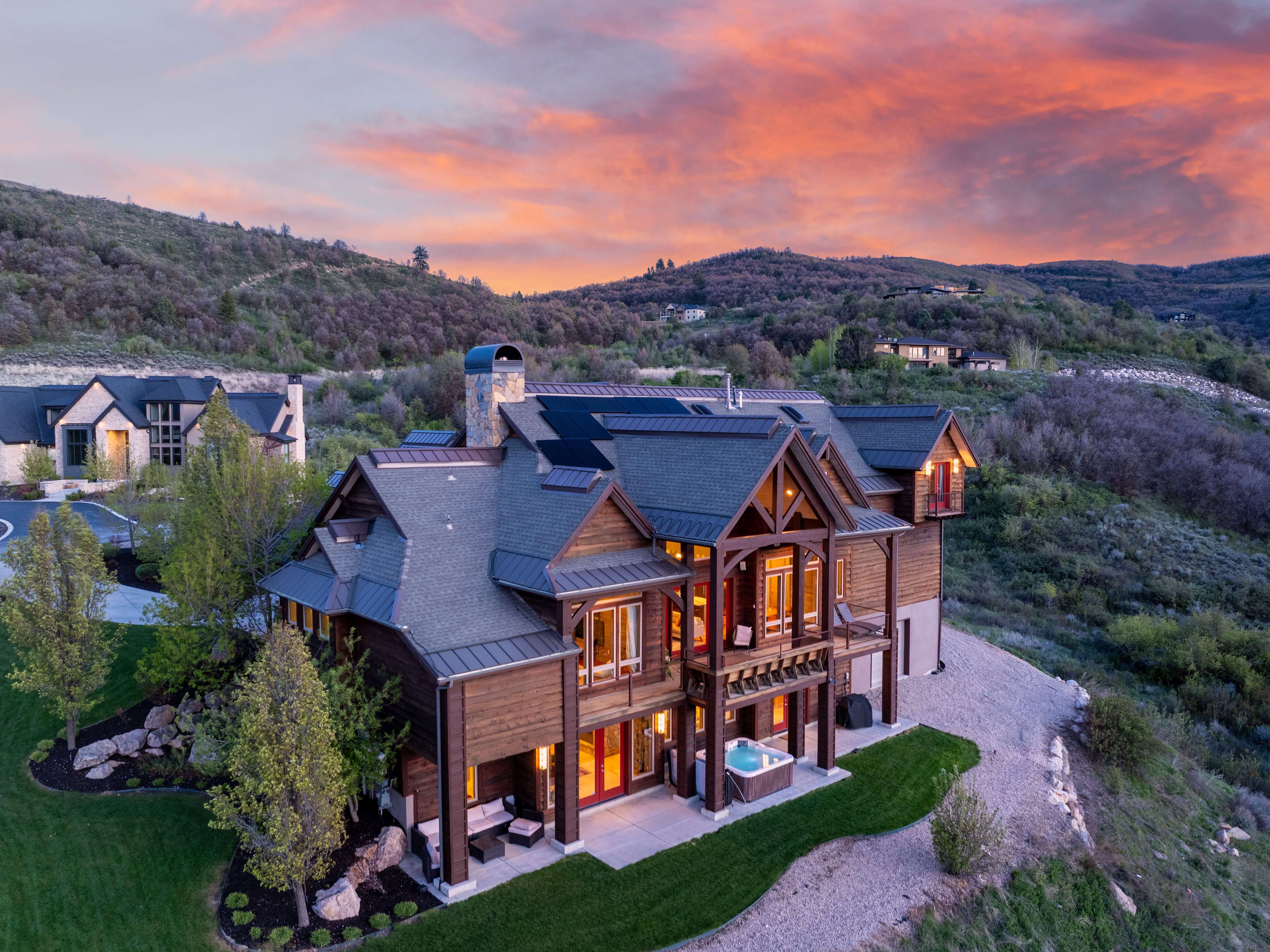 Grand mountain-style residence featuring rich wood siding and exposed timber architectural elements