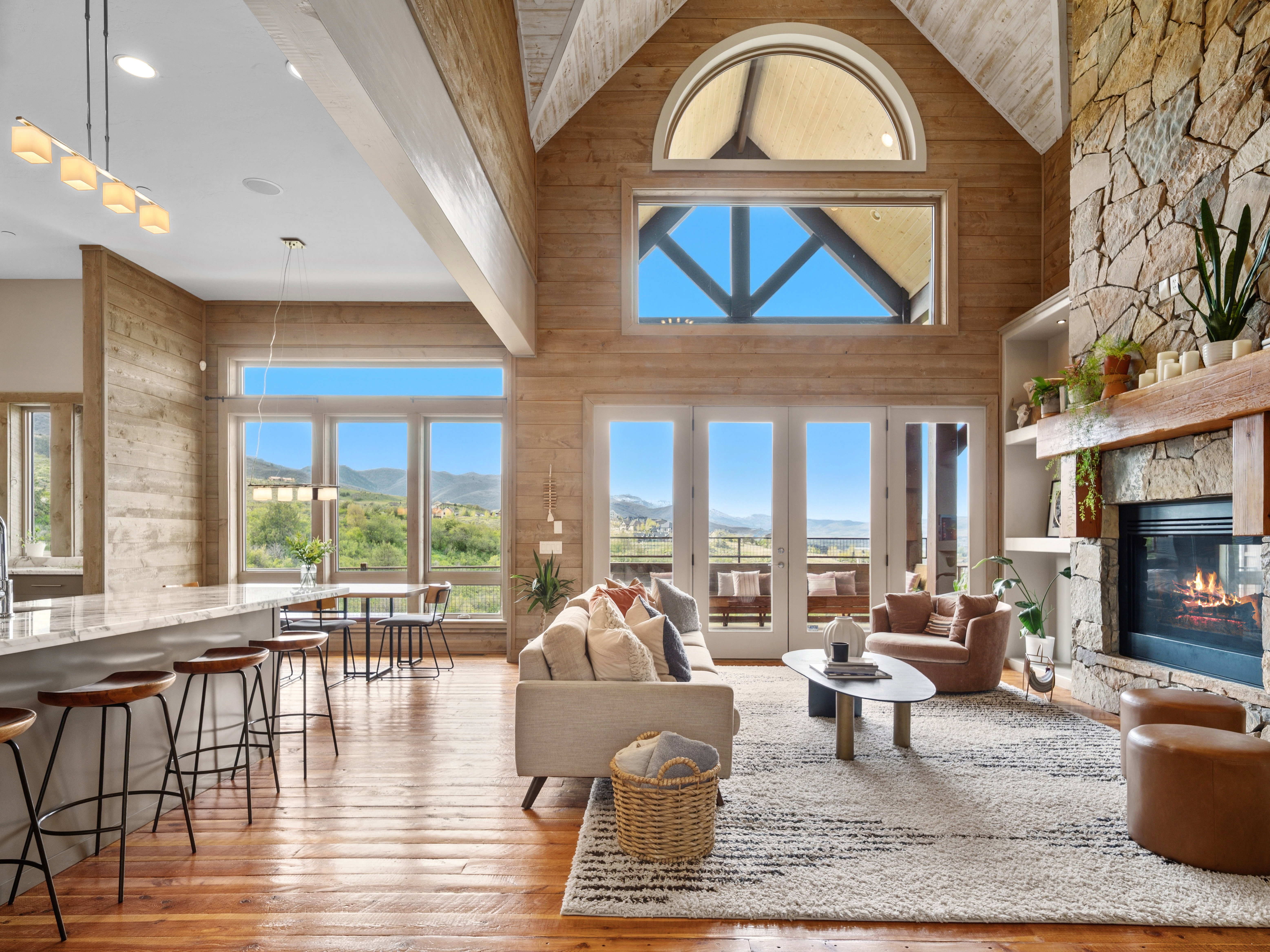 Expansive living area featuring vaulted wood-paneled ceilings and wood-finish flooring