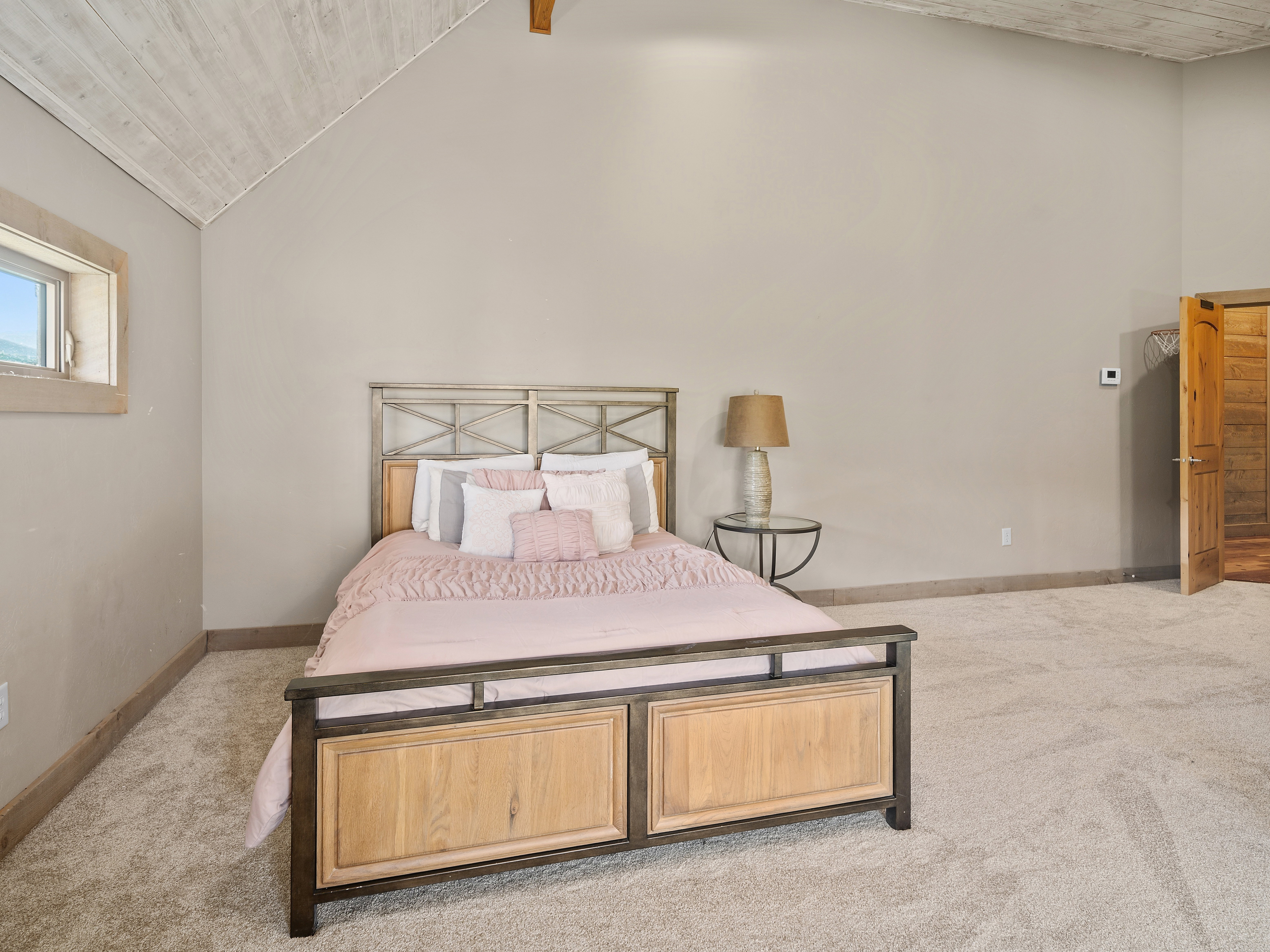 Vaulted wood-finish ceiling featuring exposed beam accents