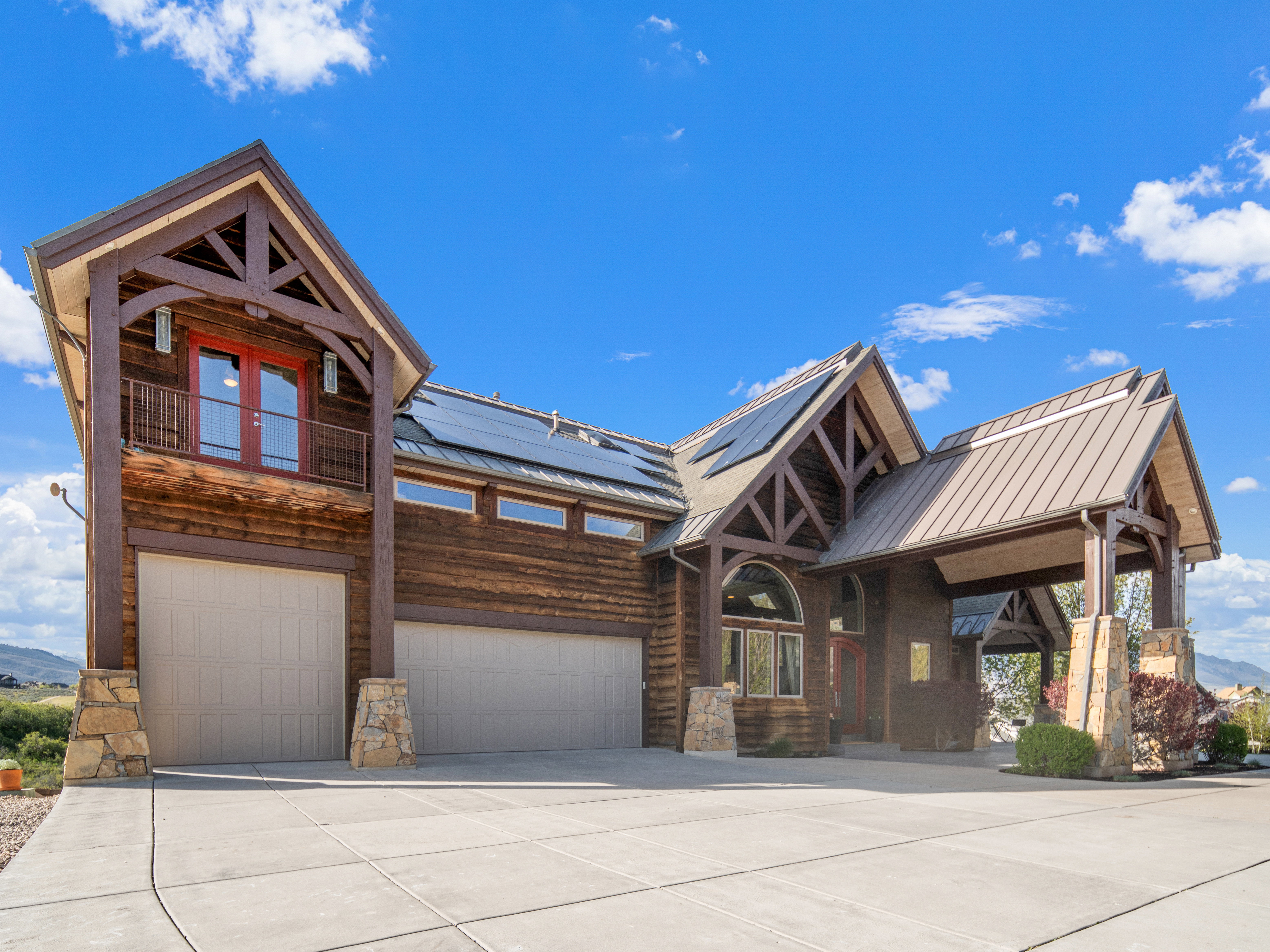 Rustic-style exterior featuring wooden siding and exposed timber trusses