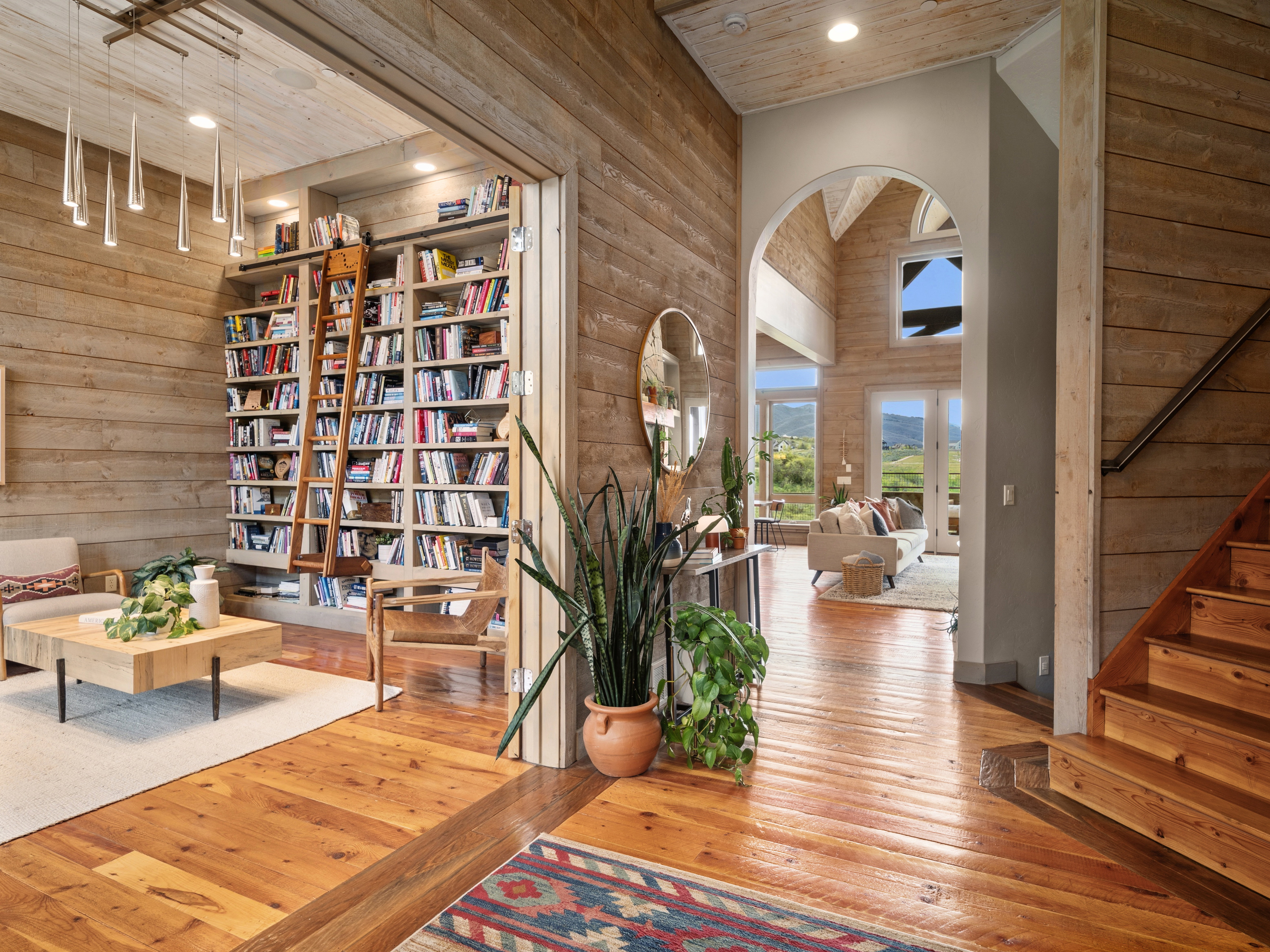 Open concept interior featuring natural wood-finish flooring and wall paneling