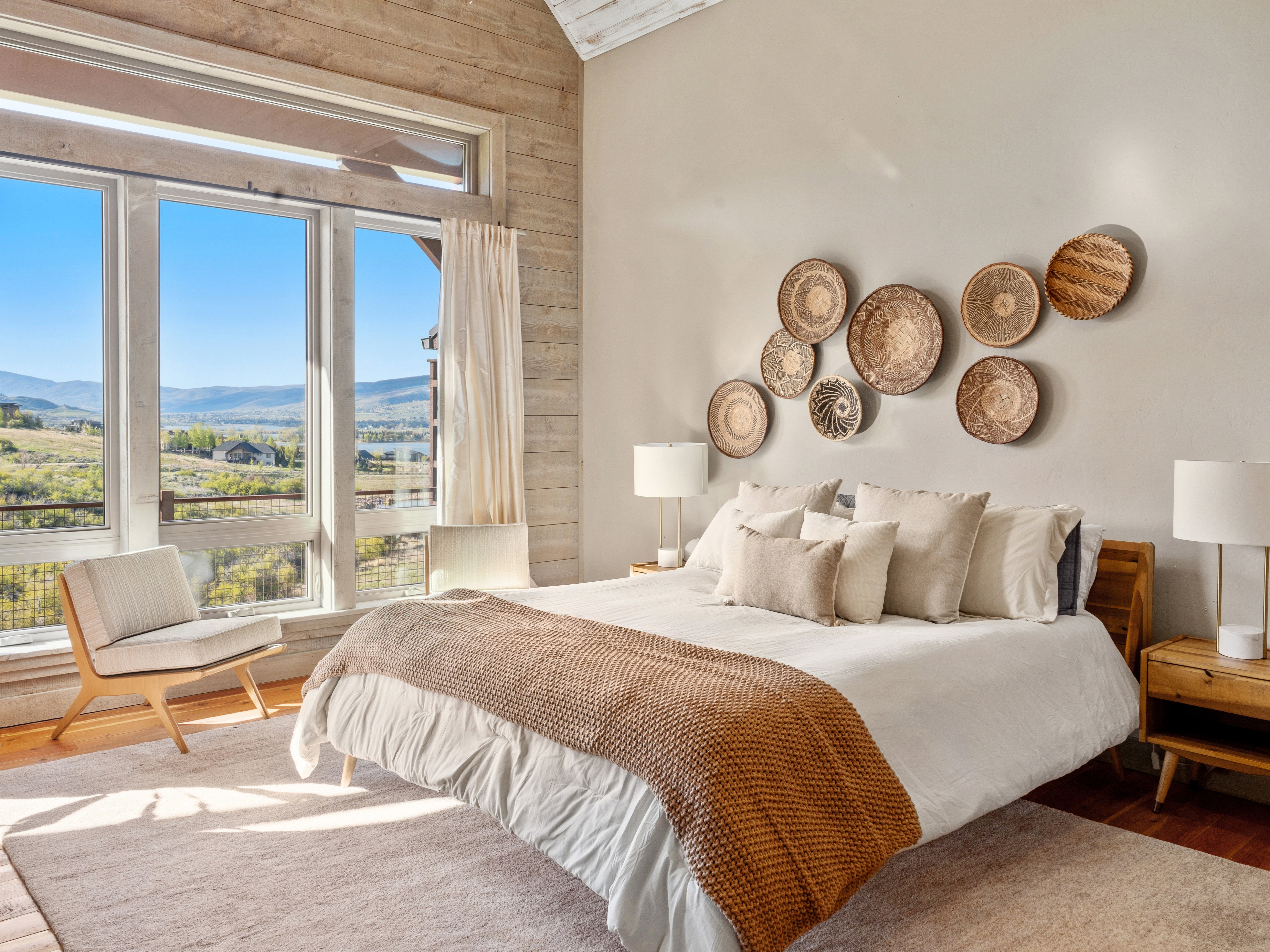 Expansive floor-to-ceiling windows showcase mountain and valley scenery