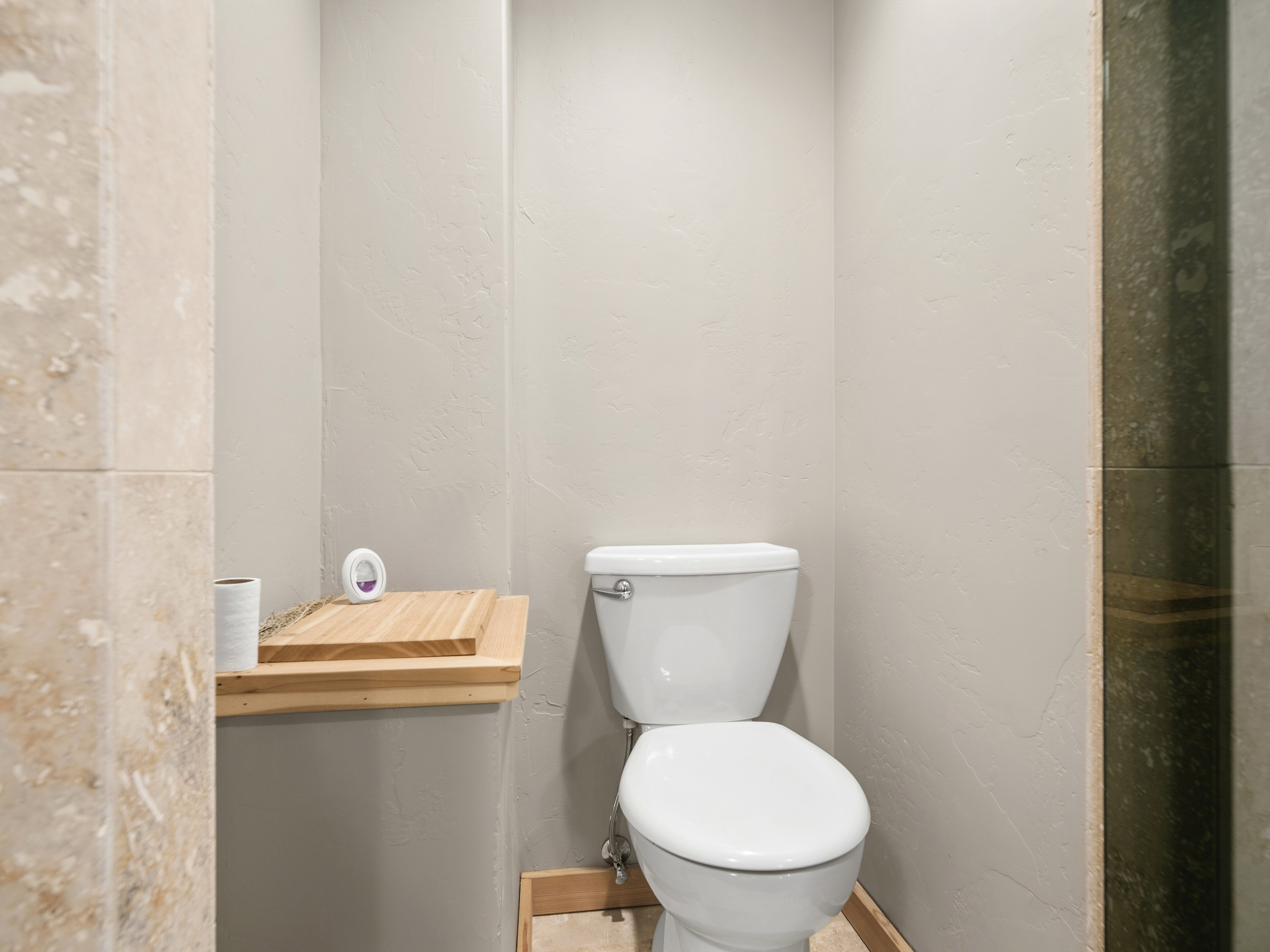 White toilet with chrome plumbing fixtures