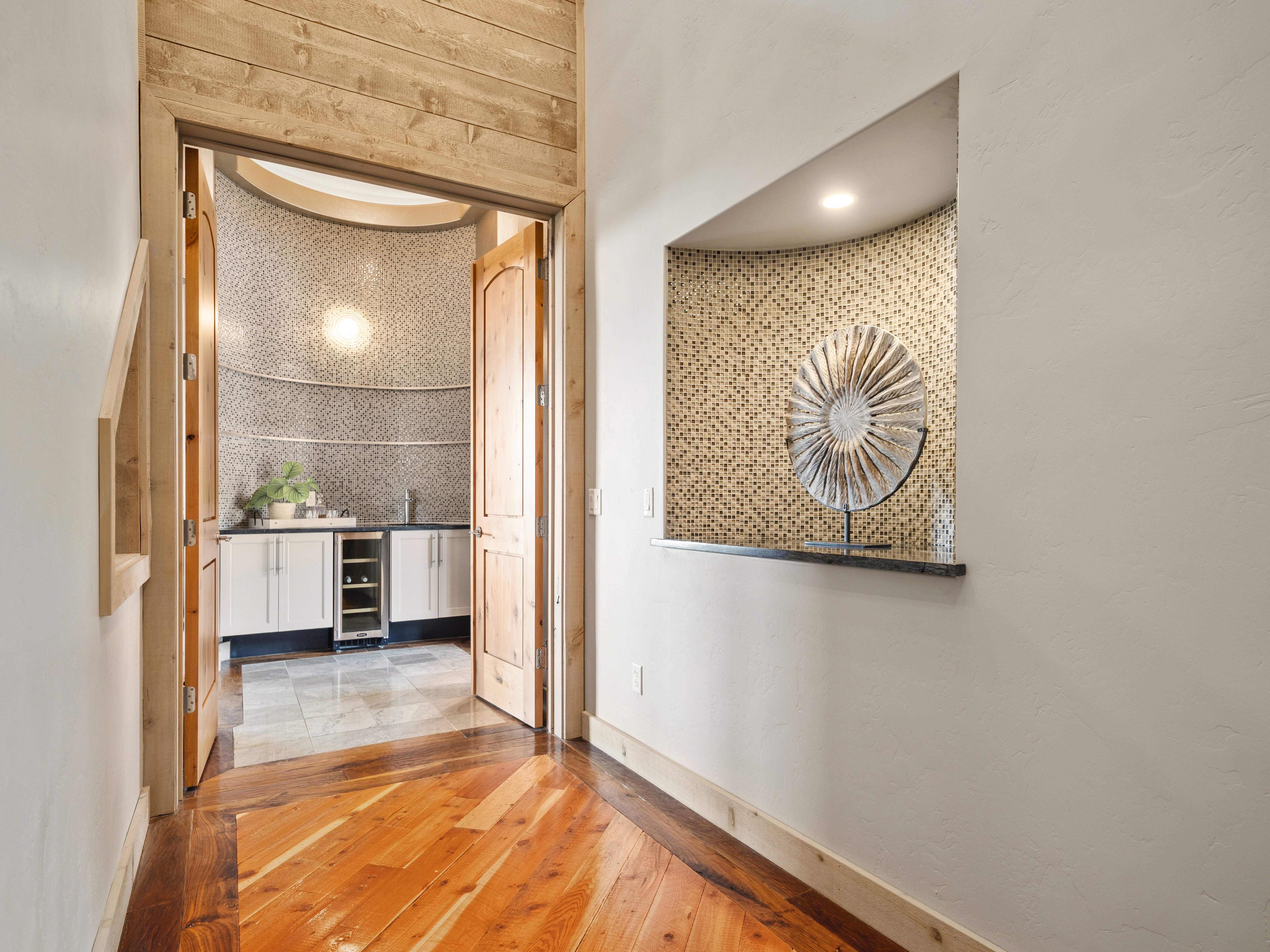 Archway featuring natural wood trim and double wooden doors