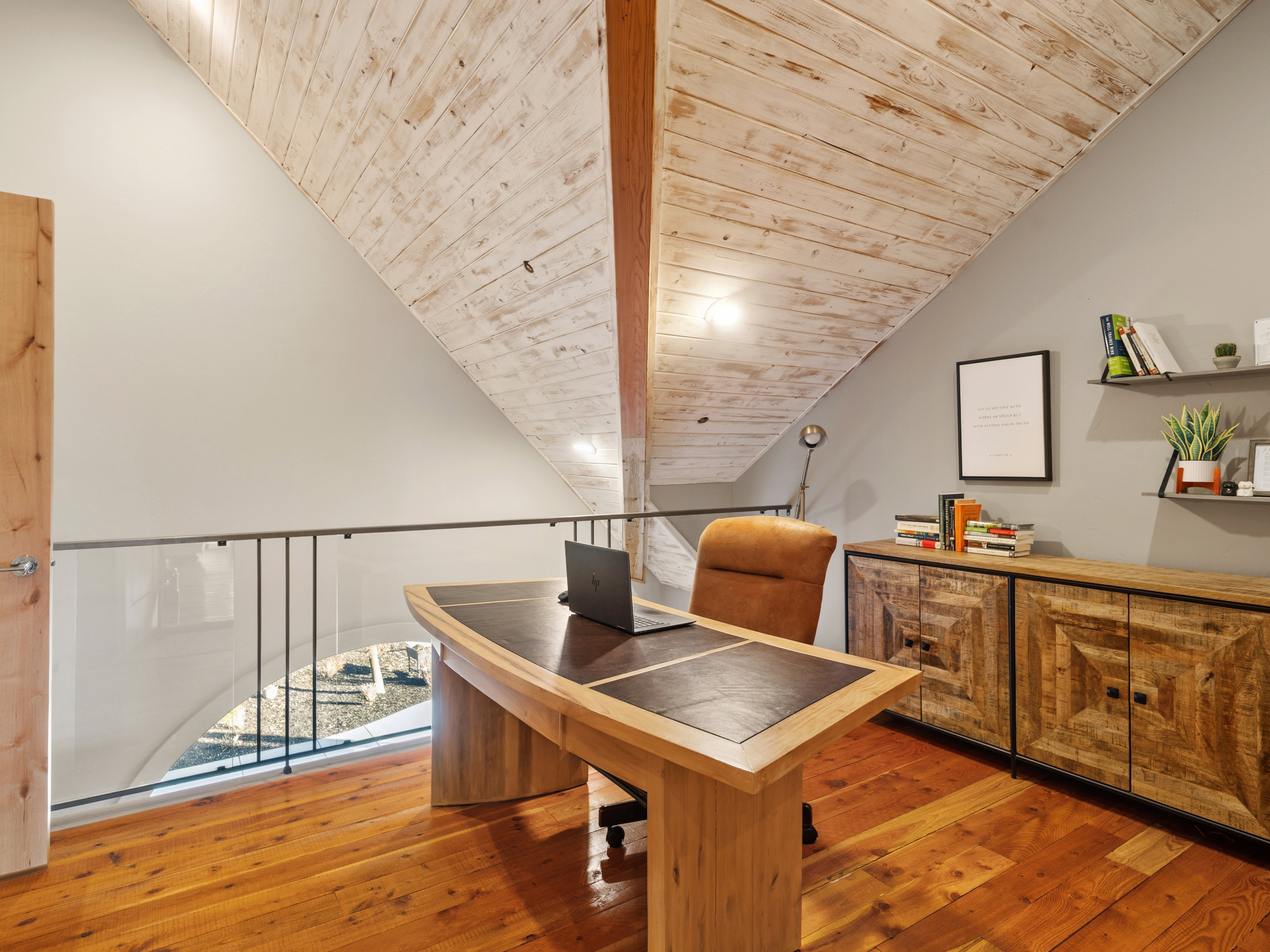 Loft space featuring wood-finish flooring, a wood-paneled ceiling, and a modern glass and metal railing