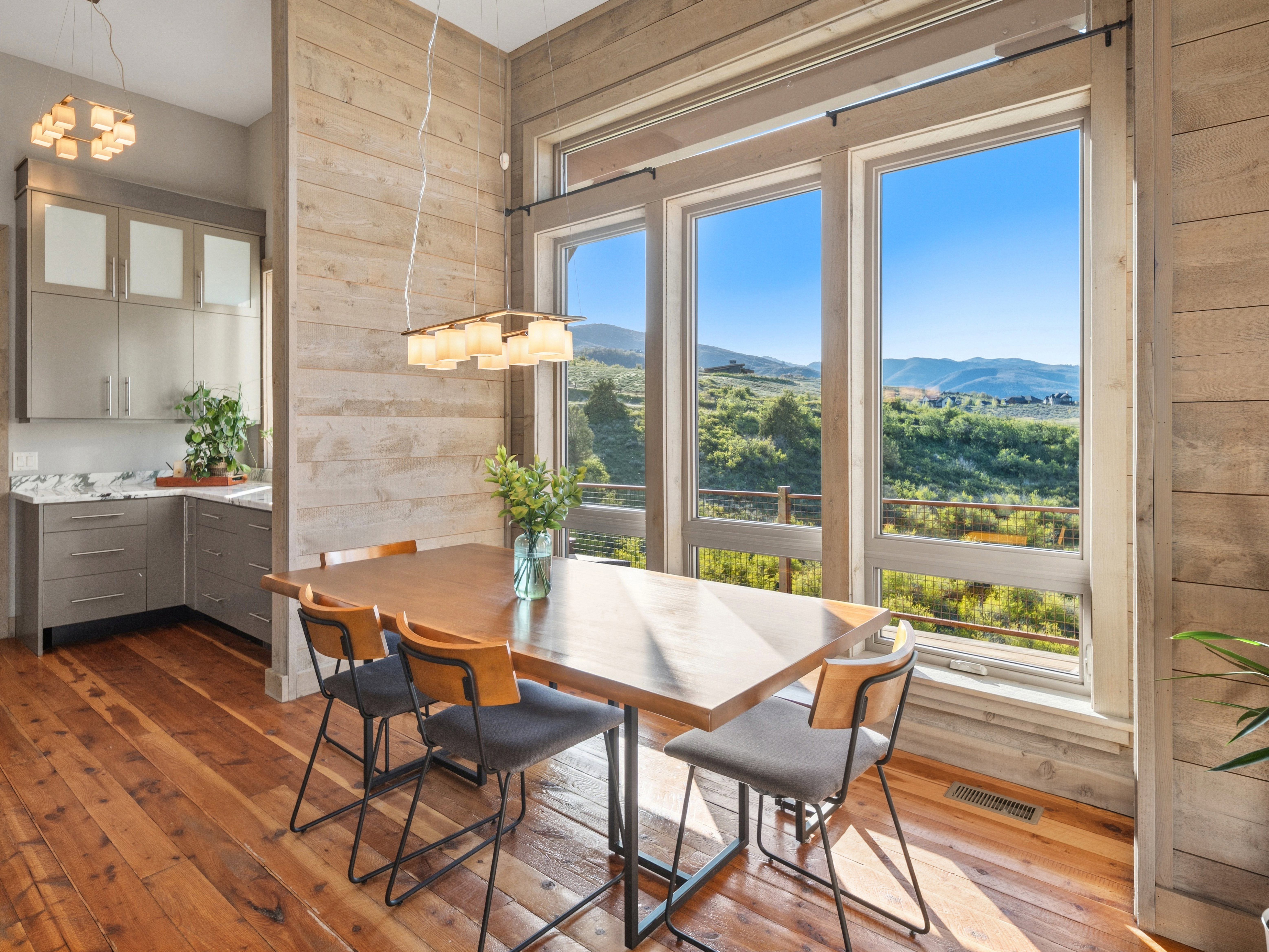 Dining area featuring floor-to-ceiling windows with expansive mountain scenery