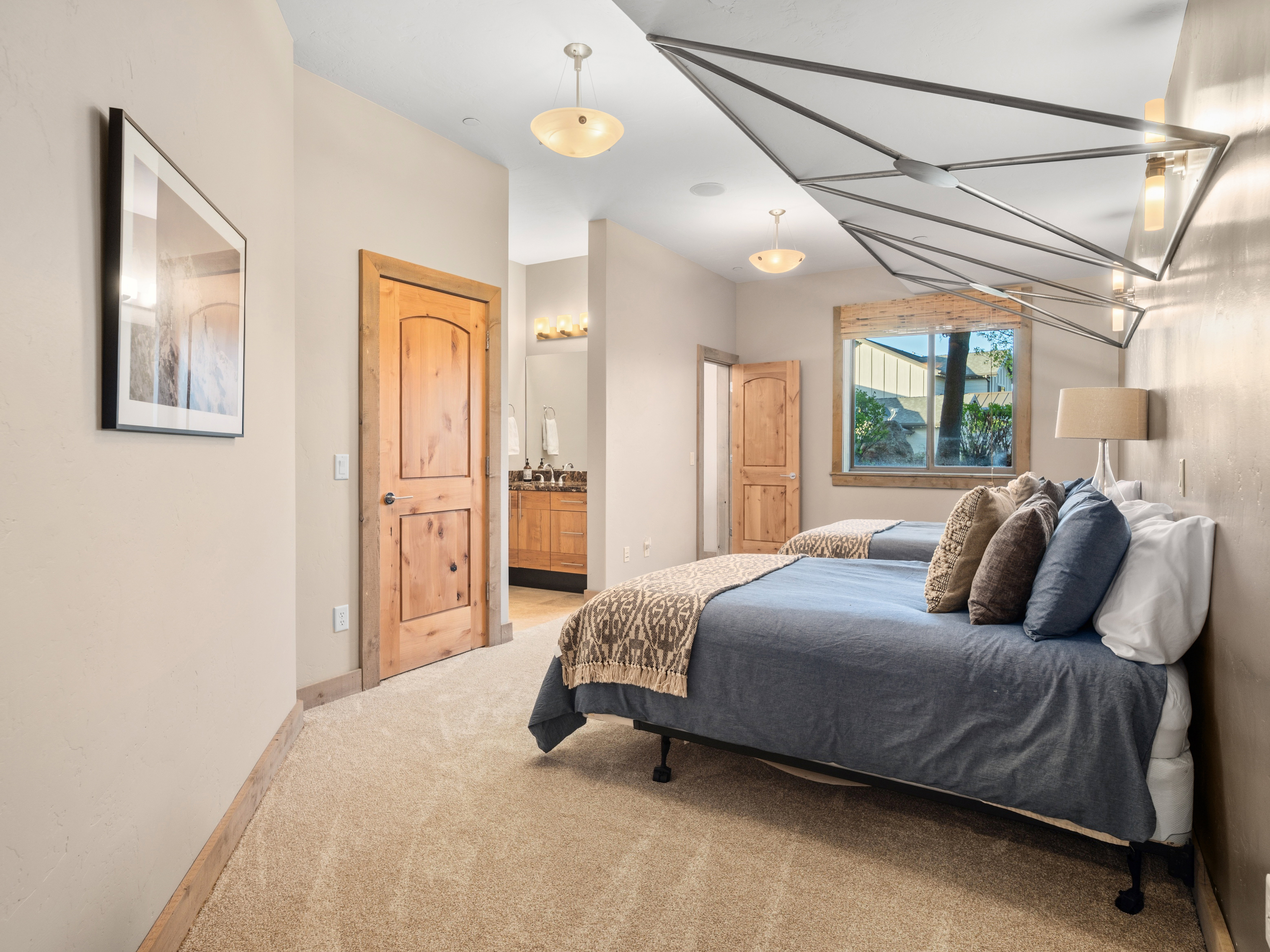 Textured wall feature with integrated lighting, wood-finish interior doors, and a window with wood trim