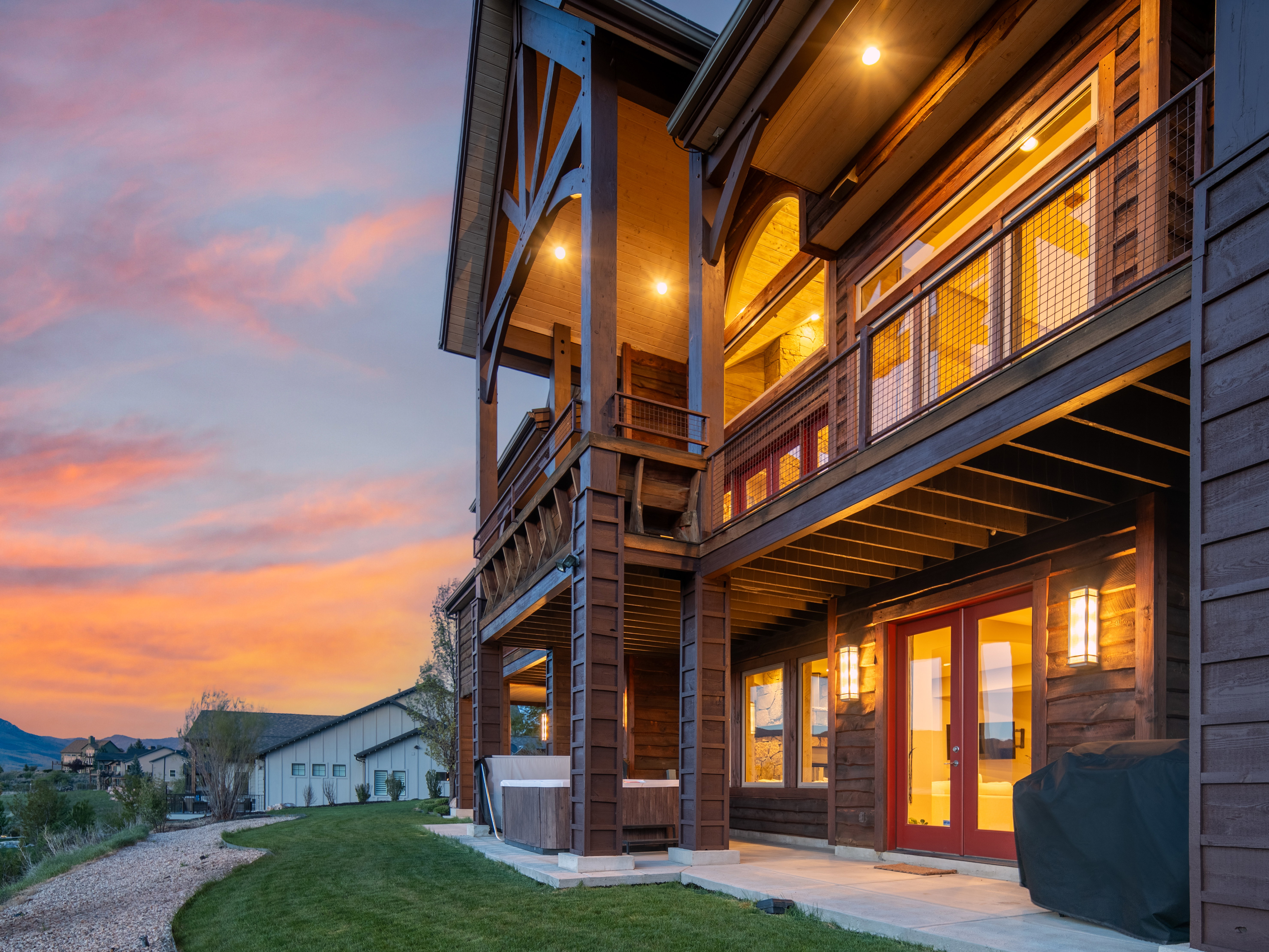 Multi-level outdoor living space featuring warm wood siding and exposed beams