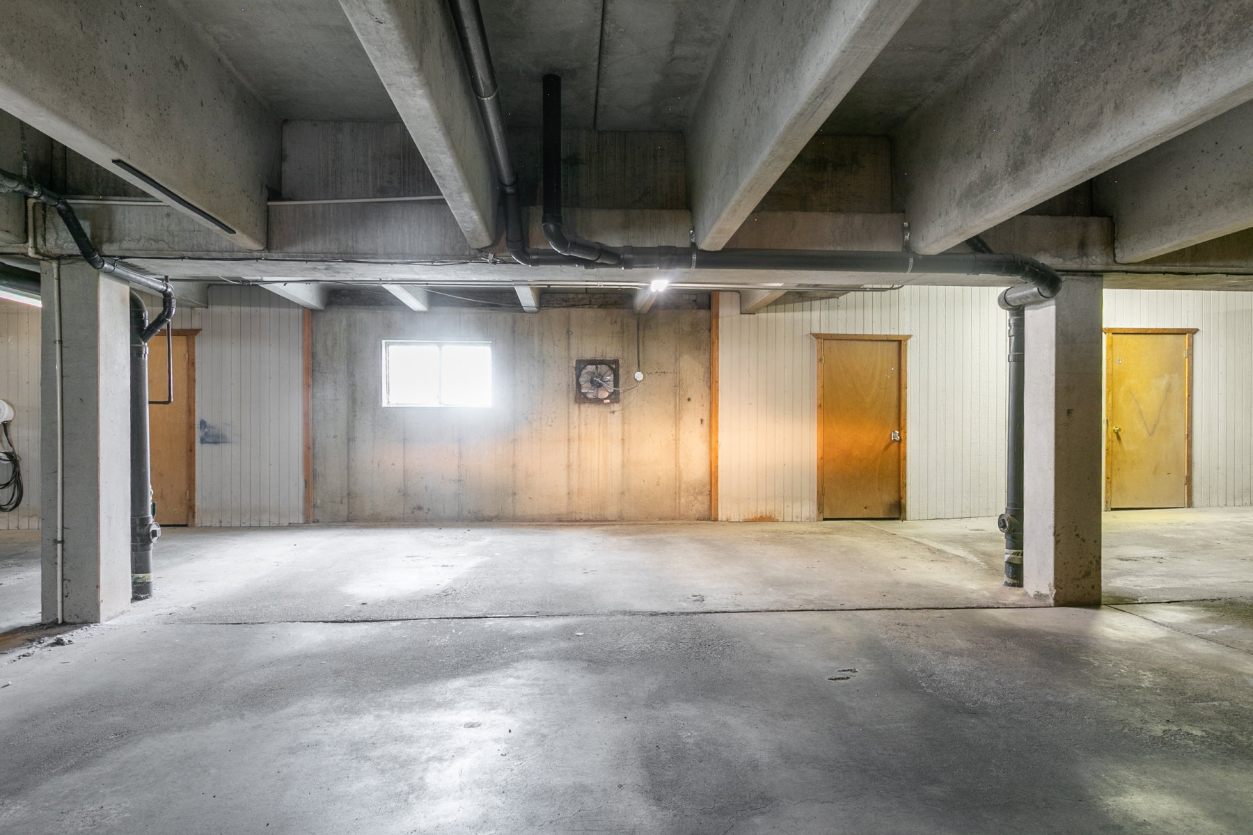 Concrete flooring with exposed ceiling beams and structural columns