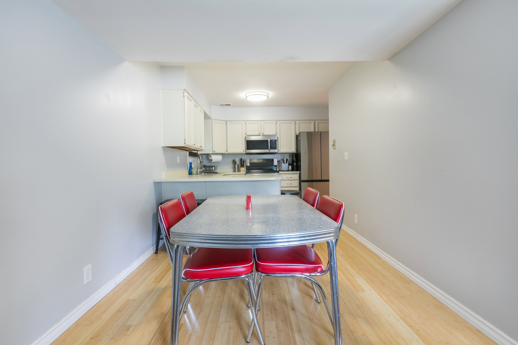Dining area featuring wood-finish flooring and light gray walls