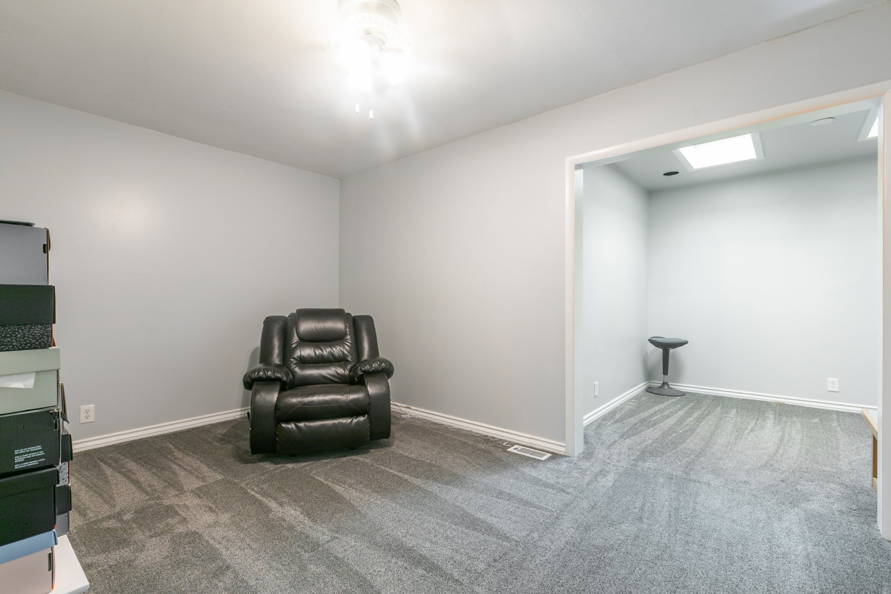 Interior space featuring light gray walls and gray patterned carpeting throughout