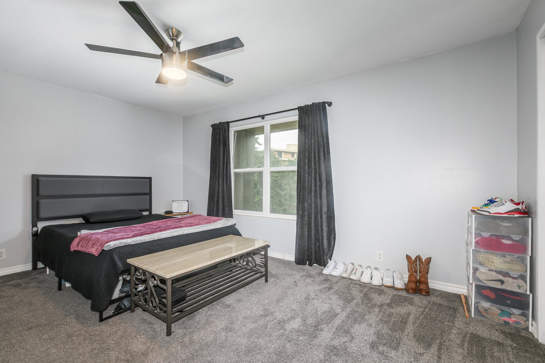 Spacious room featuring light gray walls and gray carpet