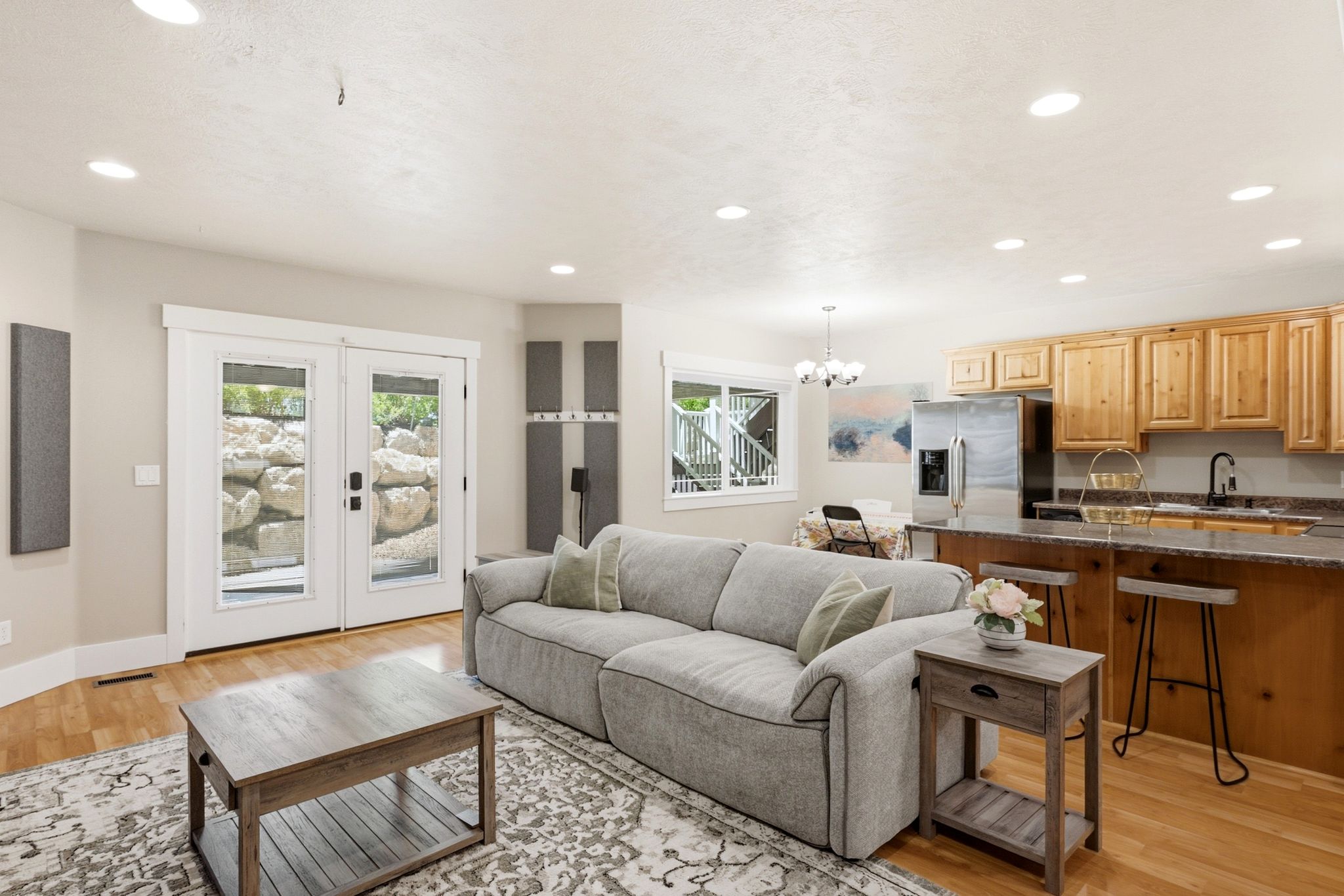 Open-concept living area featuring wood-finish flooring, recessed lighting, and white trim
