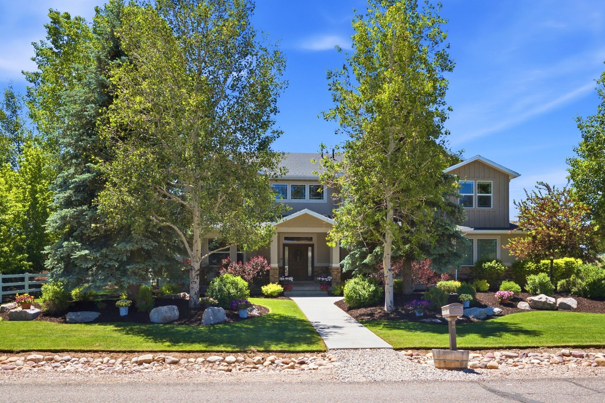 Stately residence featuring a gabled roofline, multiple windows, and a prominent front entrance