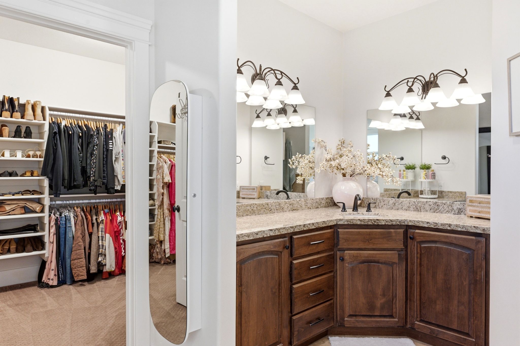 Dual vanity with a corner configuration, granite-finish countertops, and wood-finish cabinetry