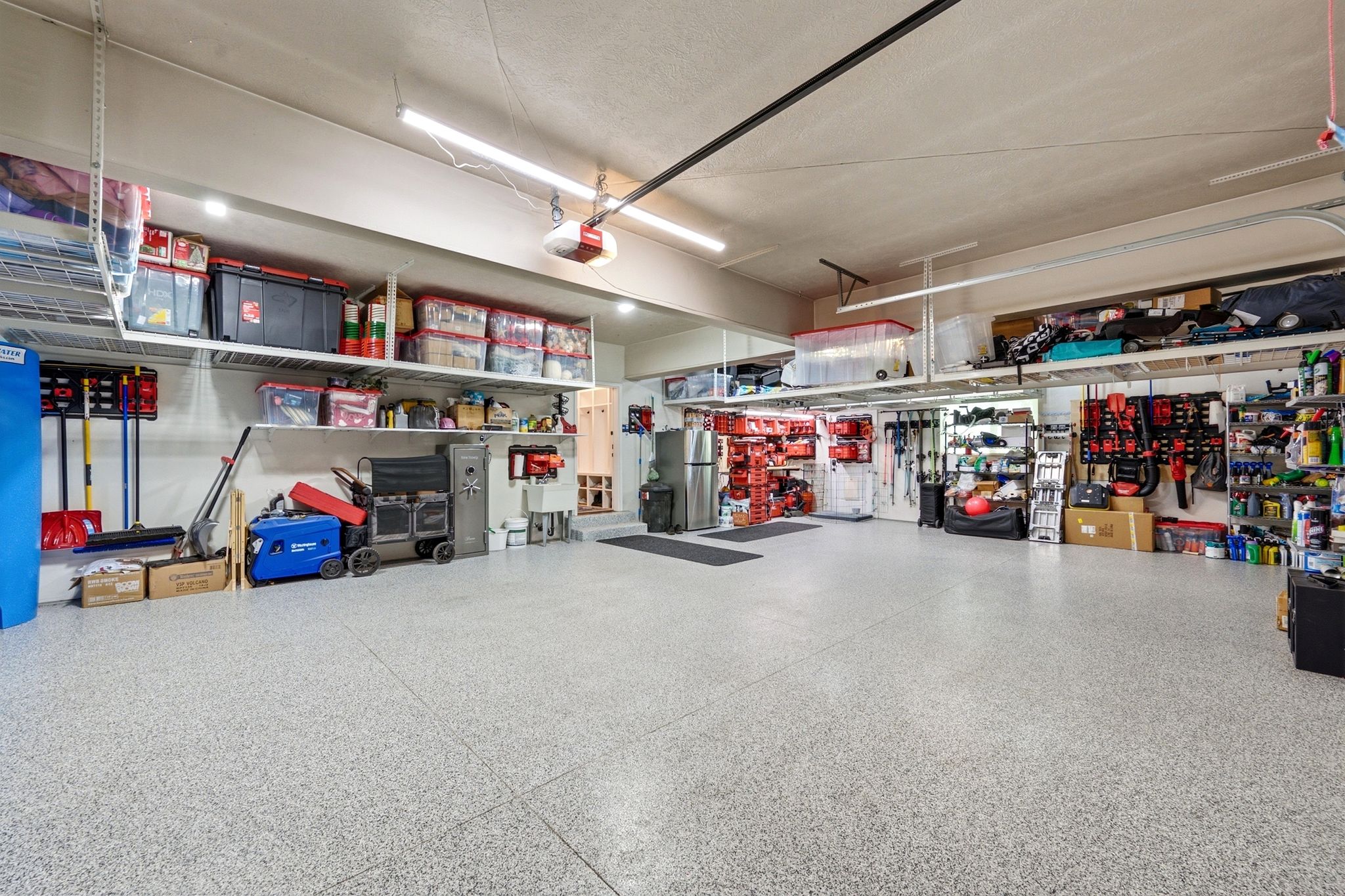 Spacious garage featuring a durable epoxy flooring finish