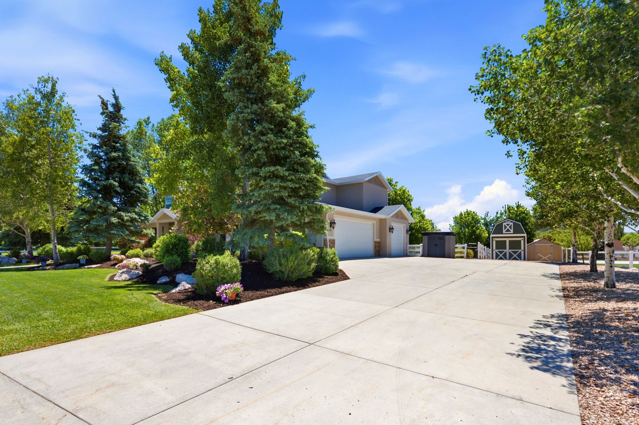 Expansive concrete driveway with a two-car garage