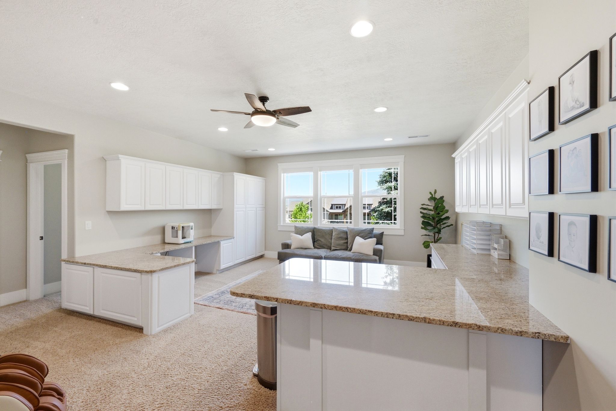 Spacious living area featuring extensive white cabinetry, light-toned countertops, and recessed lighting