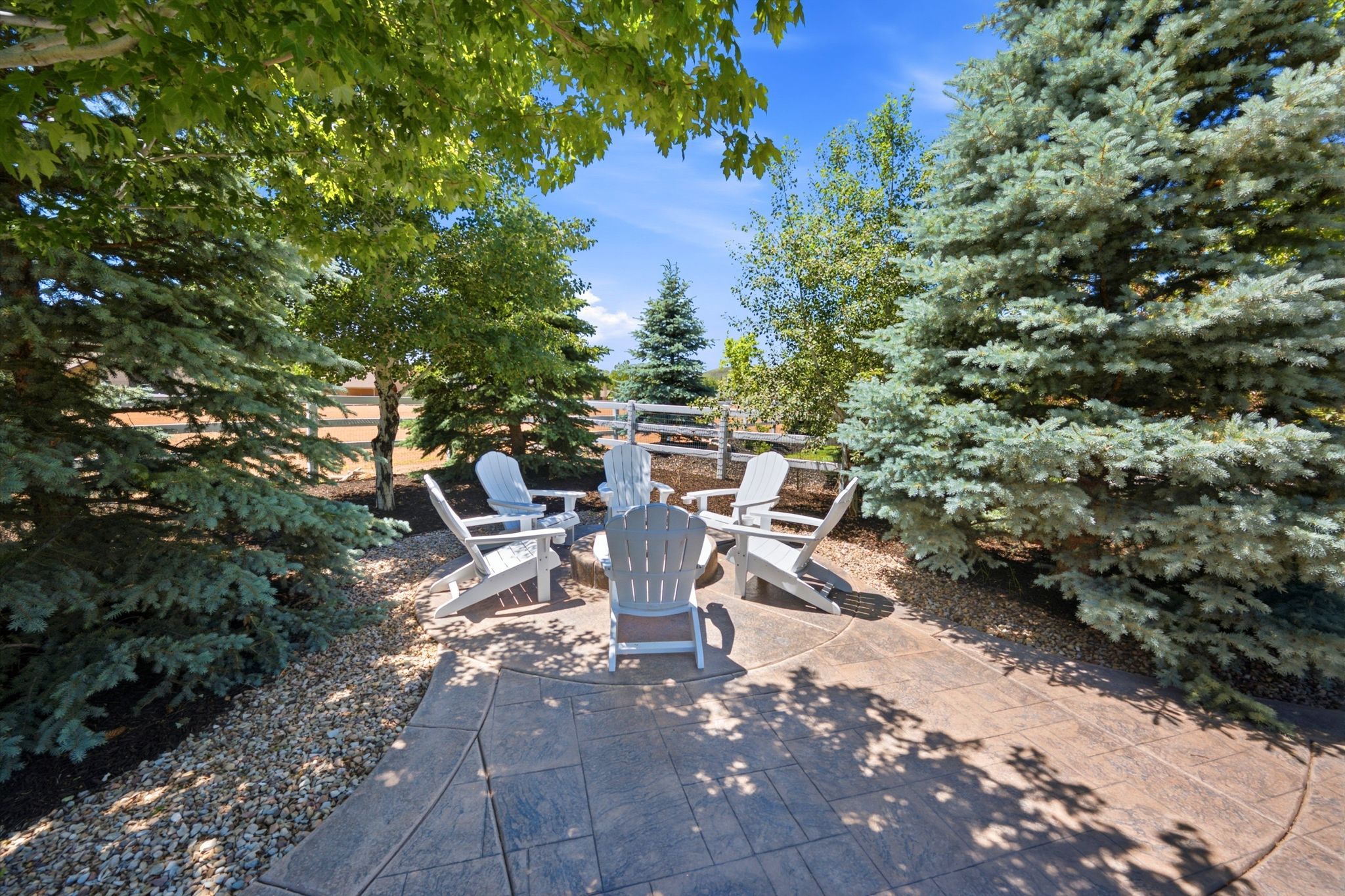 Stamped concrete patio featuring a central fire pit