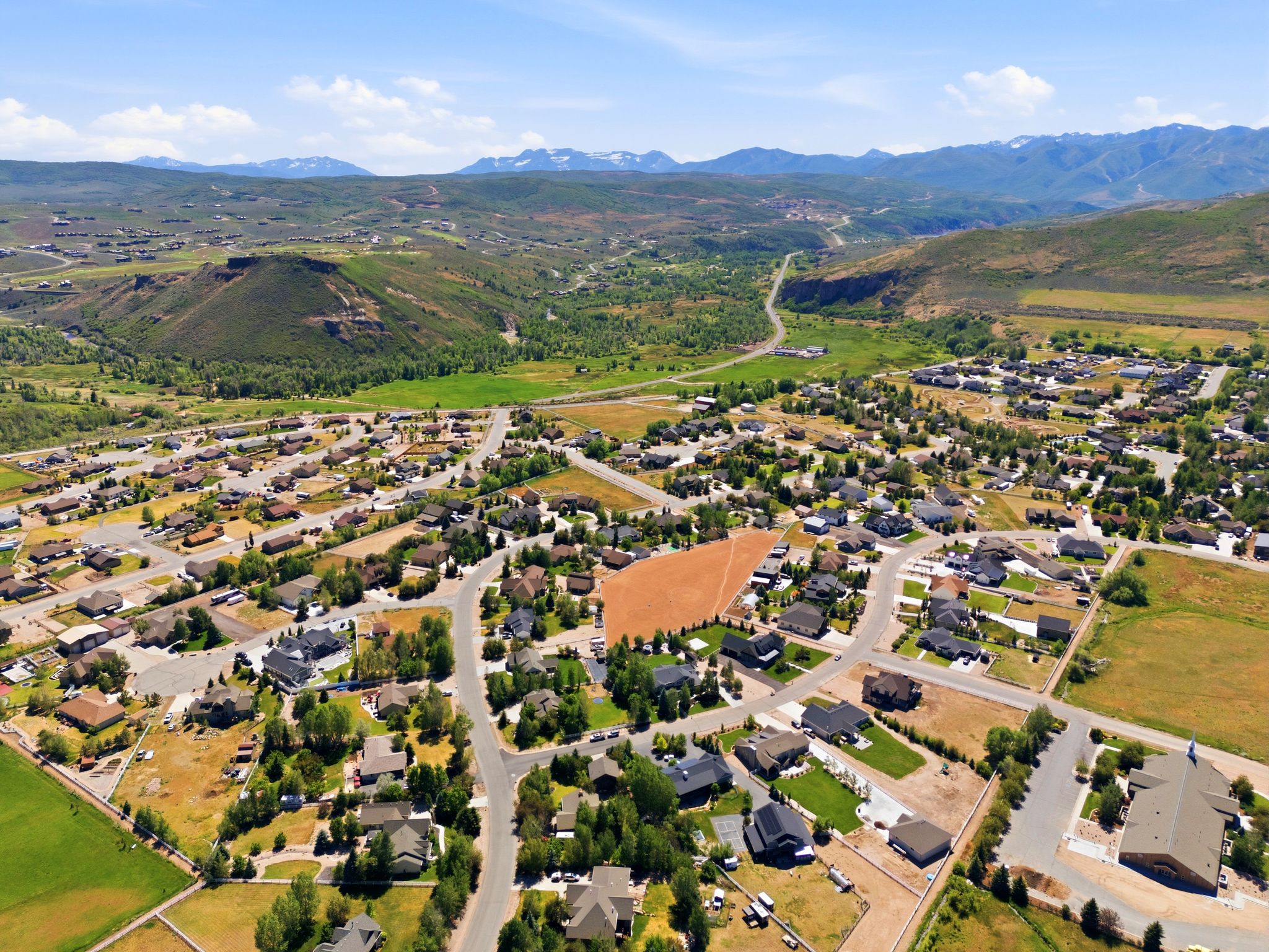 Expansive undeveloped lot with surrounding residential development