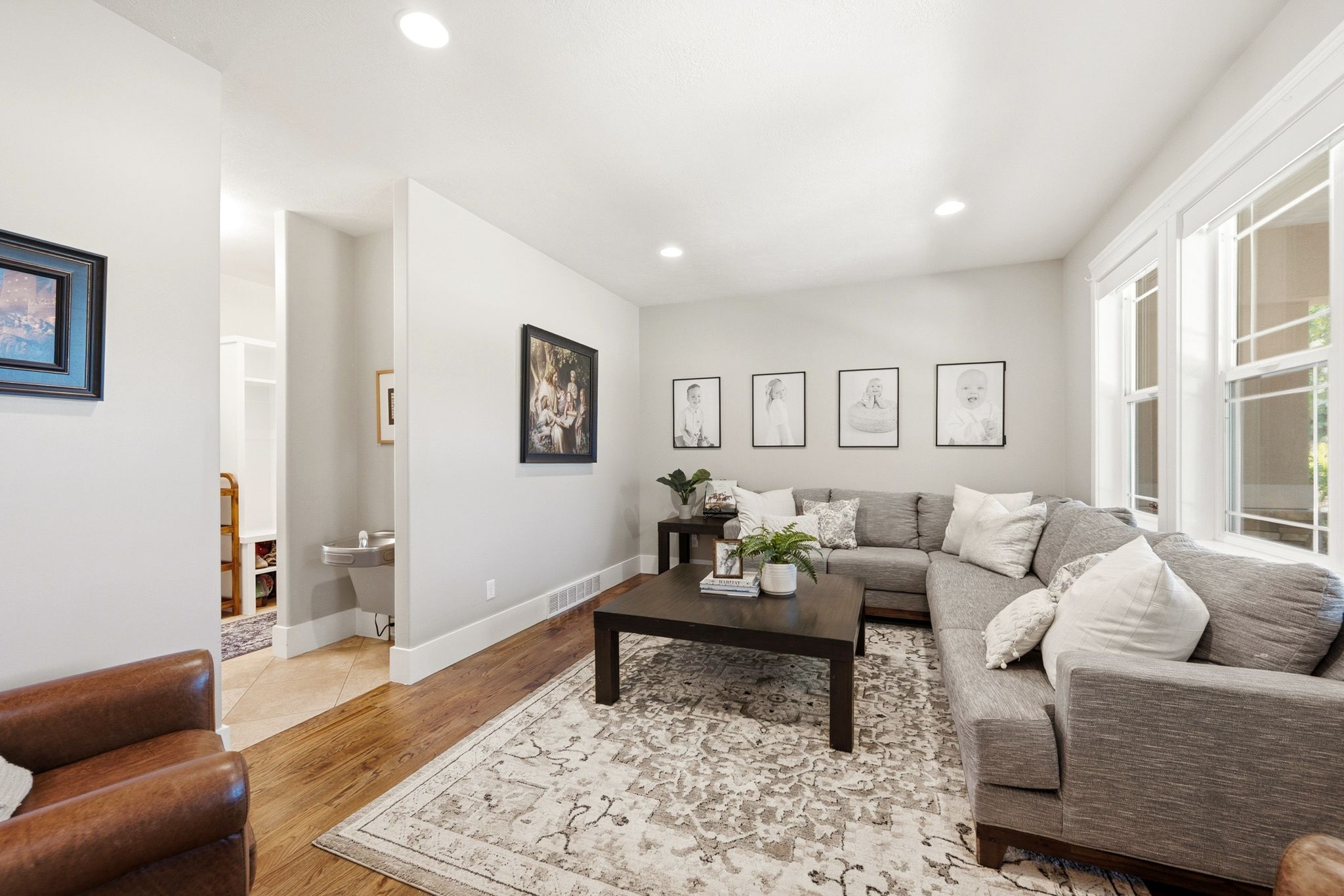 Spacious living area featuring recessed lighting, large windows, and wood-finish flooring
