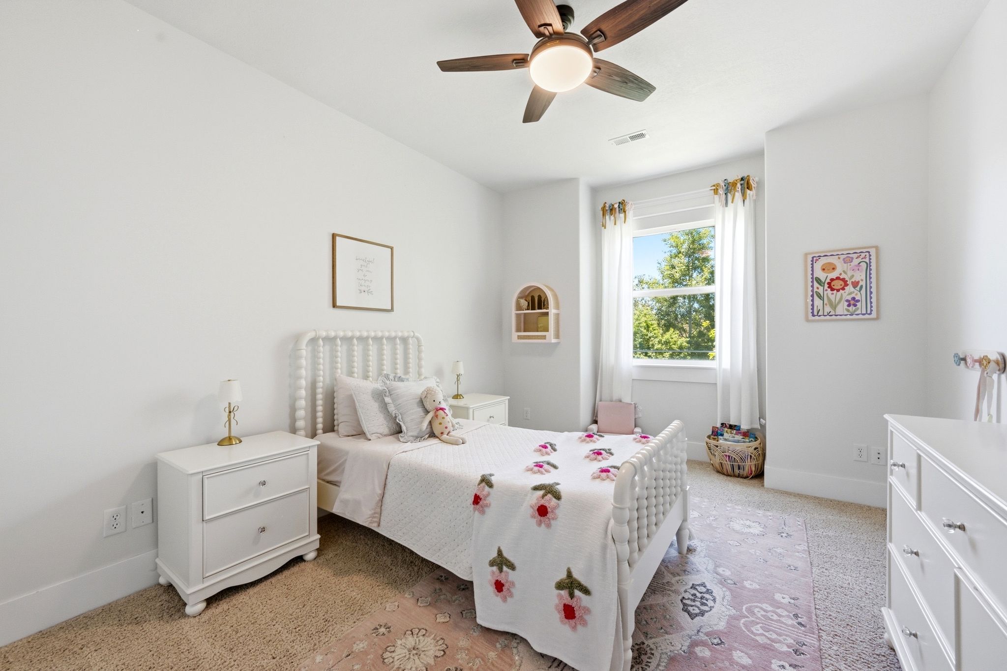 Bright room featuring a window with natural light, a ceiling fan, and light-colored carpet flooring