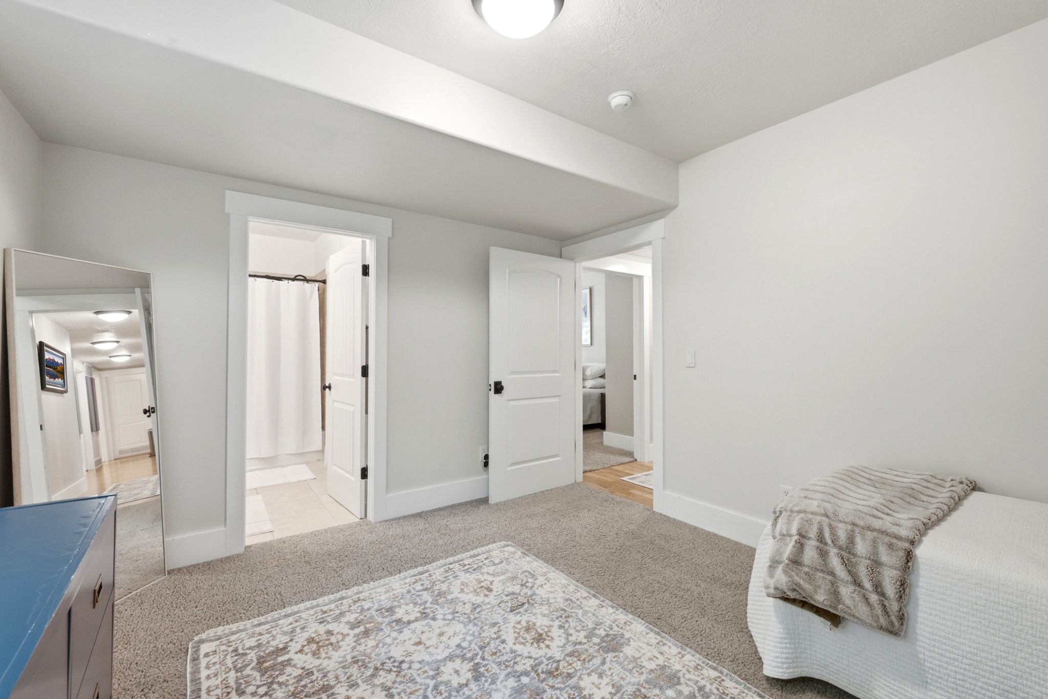 Carpeted room with light neutral walls and white trim