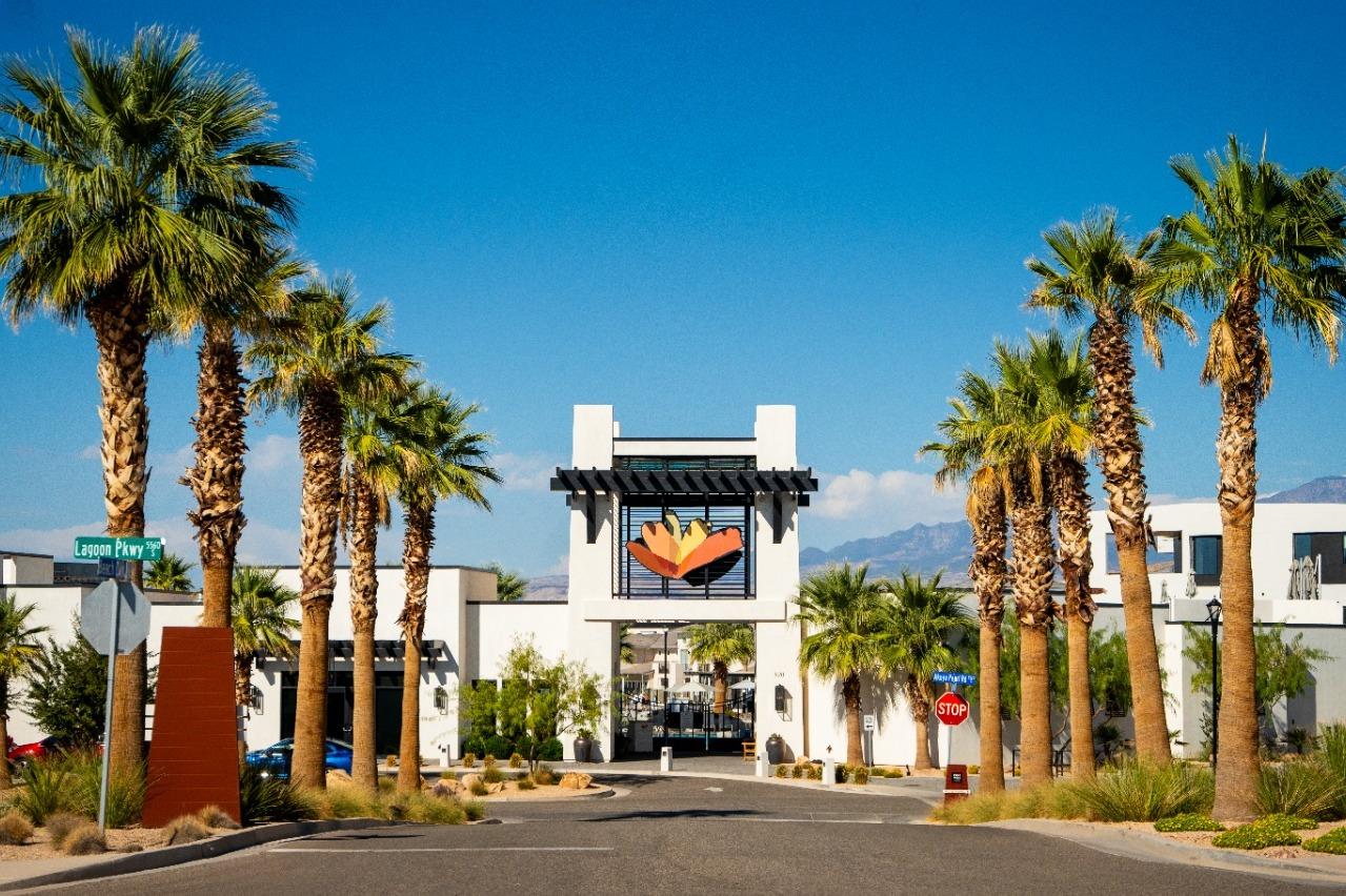 Entryway featuring a white stucco archway and a prominent art installation