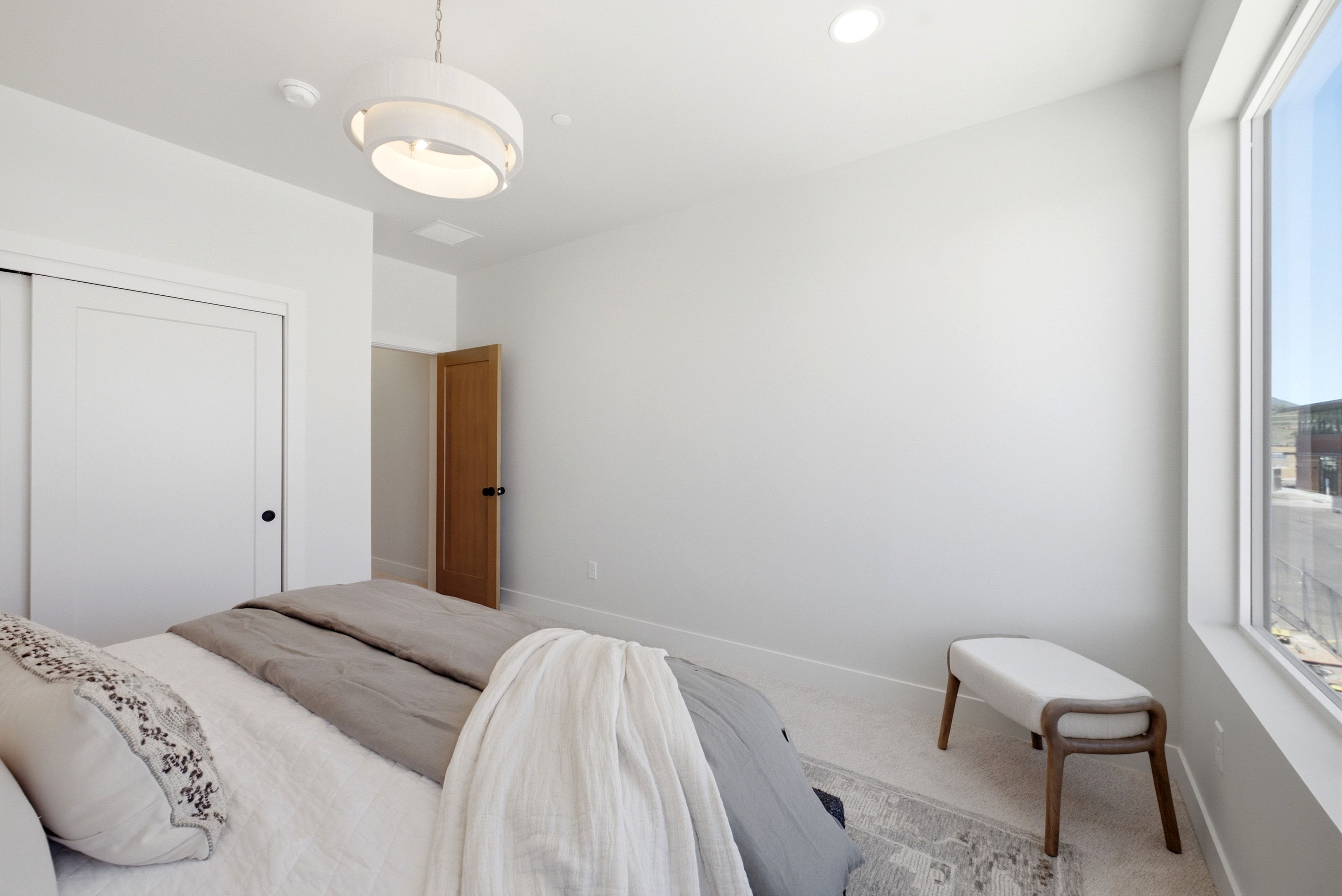 Interior room featuring a large window, recessed lighting, and a contemporary chandelier