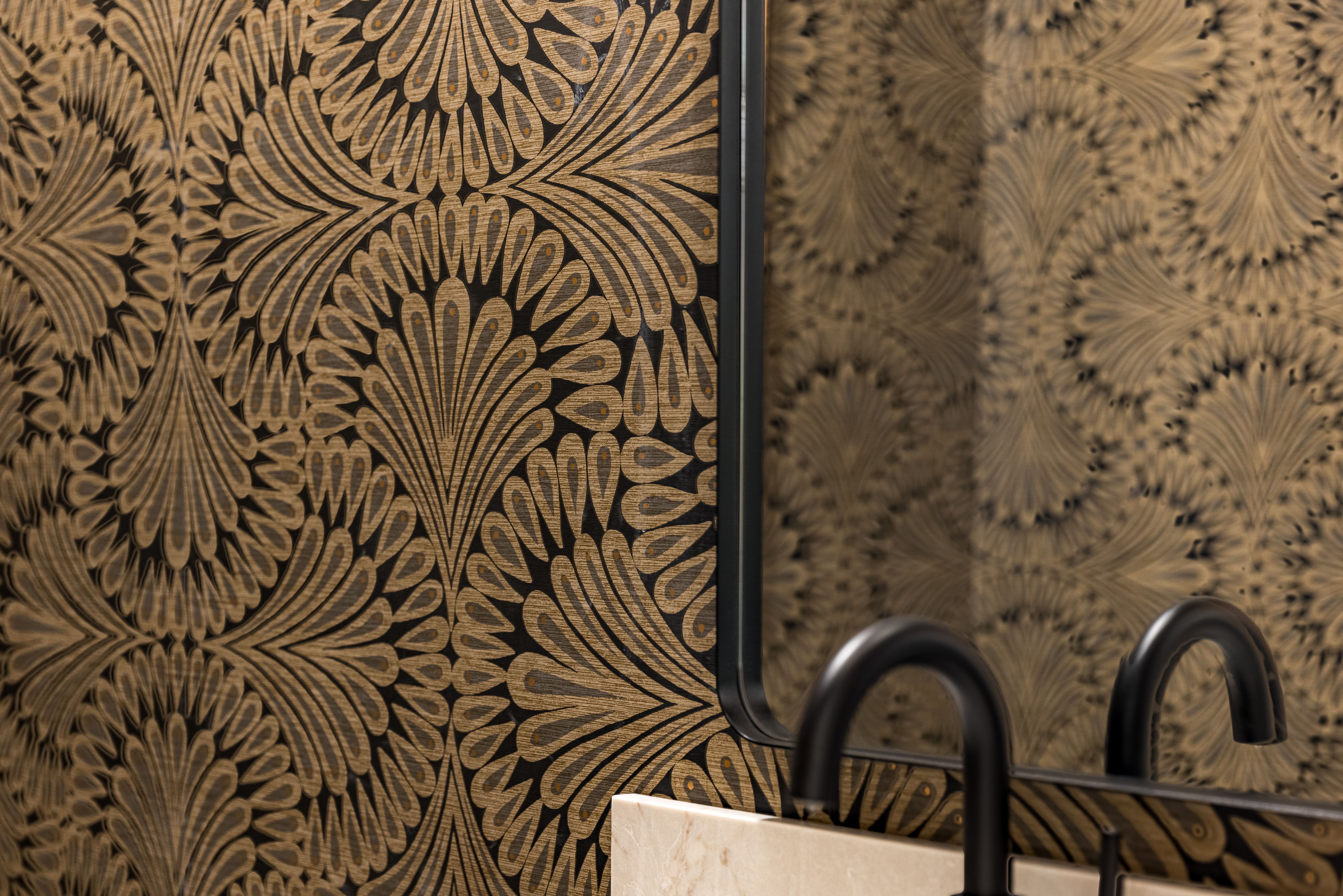 Decorative wallpaper with a repeating fan-like pattern in black and gold tones