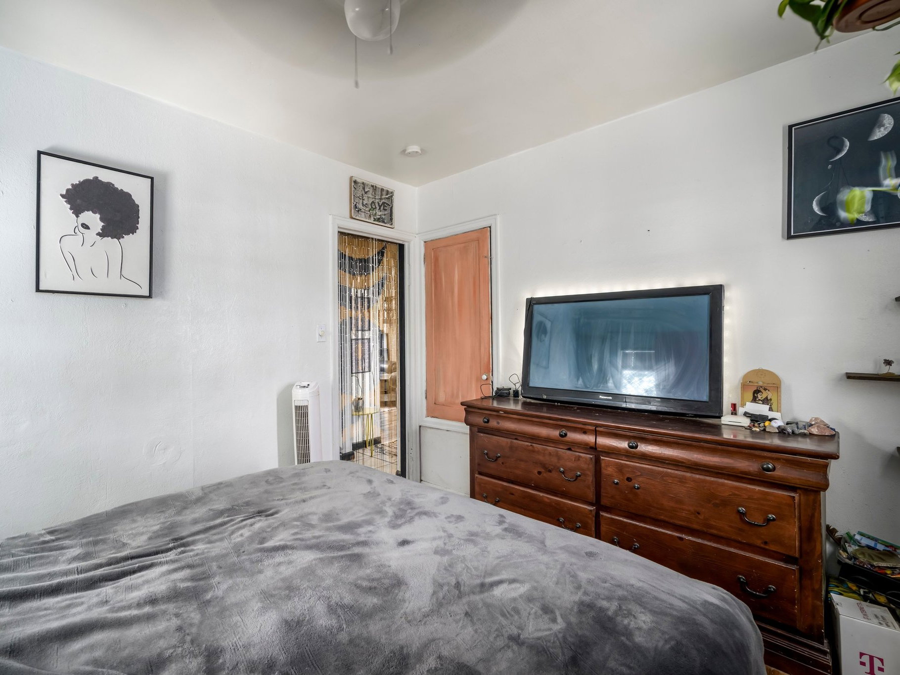 Bedroom featuring white painted walls and a ceiling fan