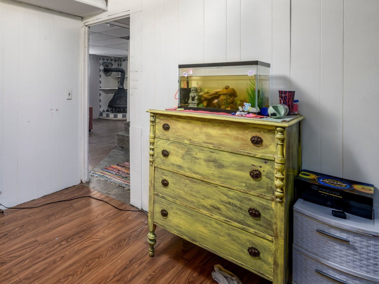 Room featuring wood-finish flooring, white paneled walls, and a drop ceiling with recessed lighting